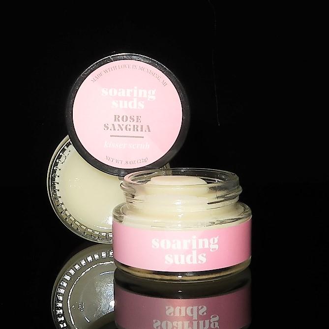 A jar of Rose Sangria Kisser Scrub with a refreshing rose scent, showcasing its natural ingredients and smooth texture.