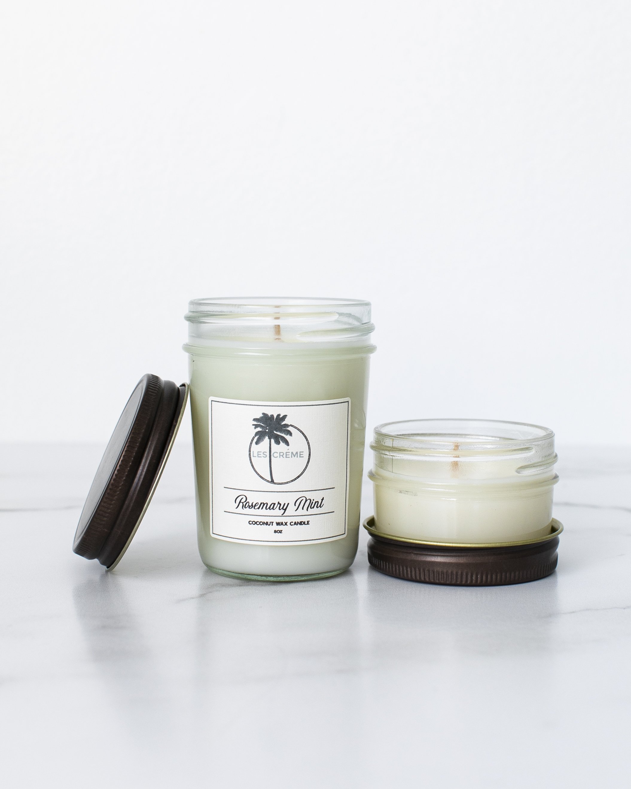 Rosemary Mint Scent Coconut Wax Candle in a stylish glass jar, showcasing its natural ingredients and inviting aroma.