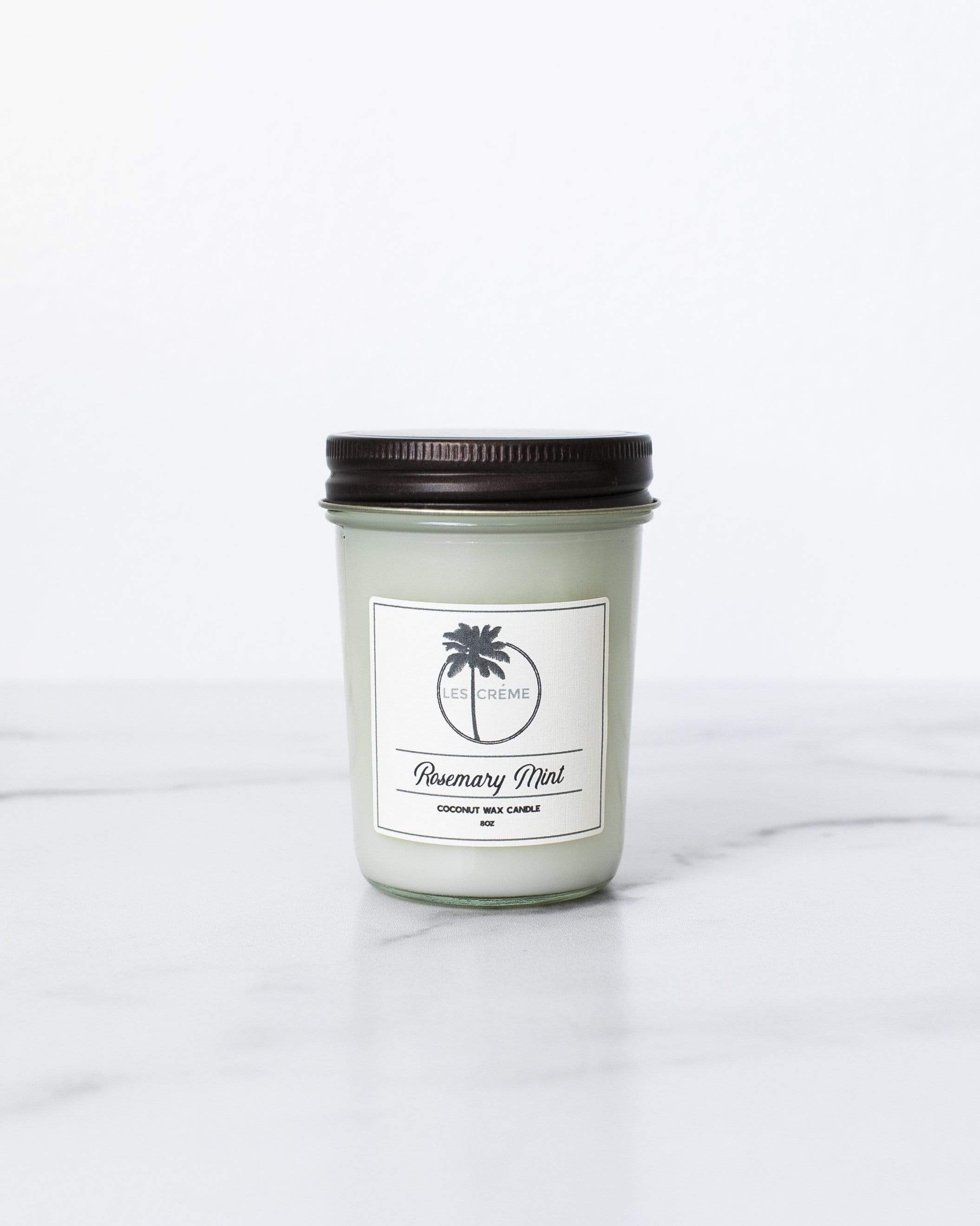 Rosemary Mint Scent Coconut Wax Candle in a stylish glass jar, showcasing its natural ingredients and inviting aroma.