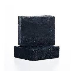 Sacred Noir Charcoal Soap bar with a rich blend of oils and activated charcoal, showcasing its dark color and creamy texture.