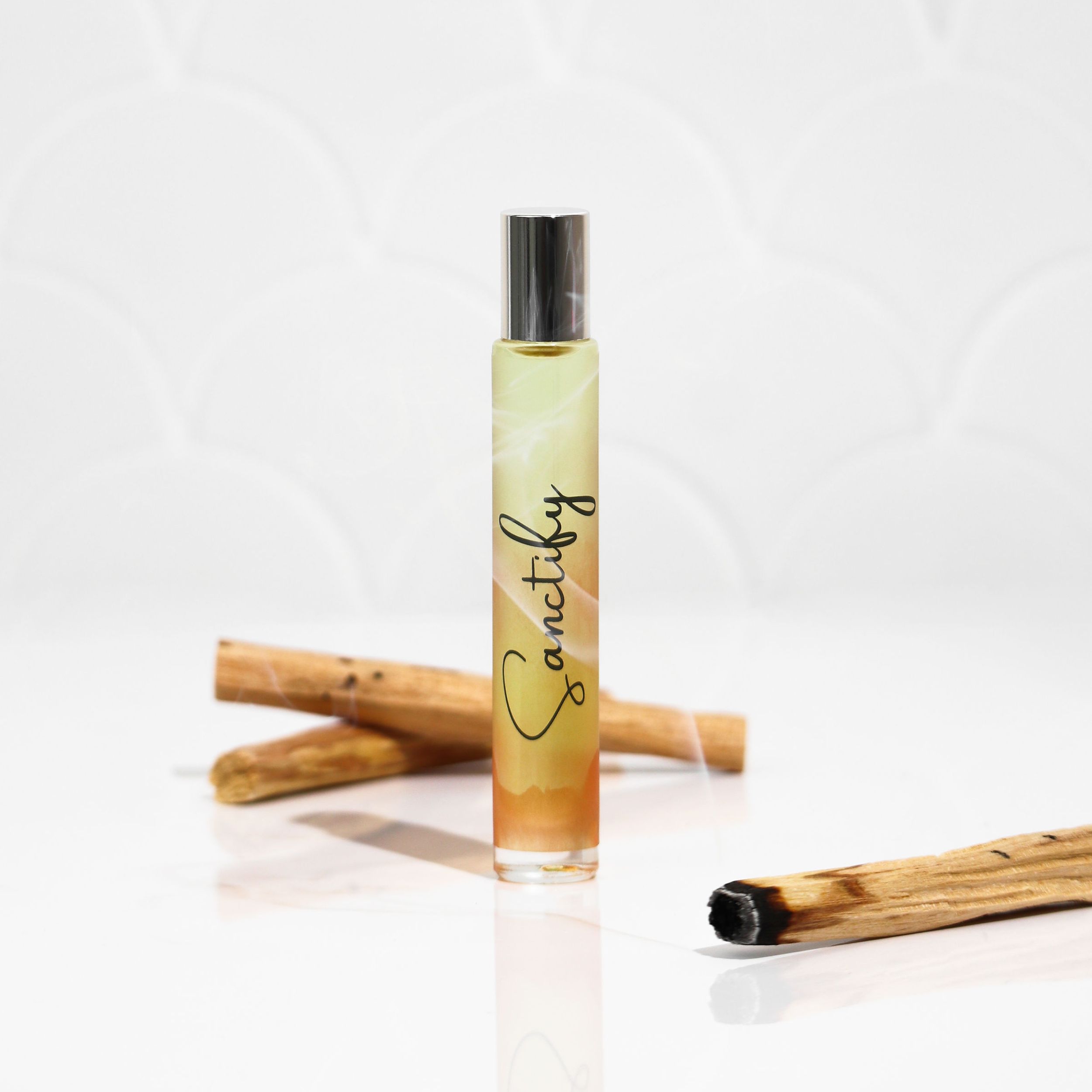 Sanctify Rollerball Perfume featuring a sleek design with Palo Santo fragrance notes, perfect for travel and gifting.