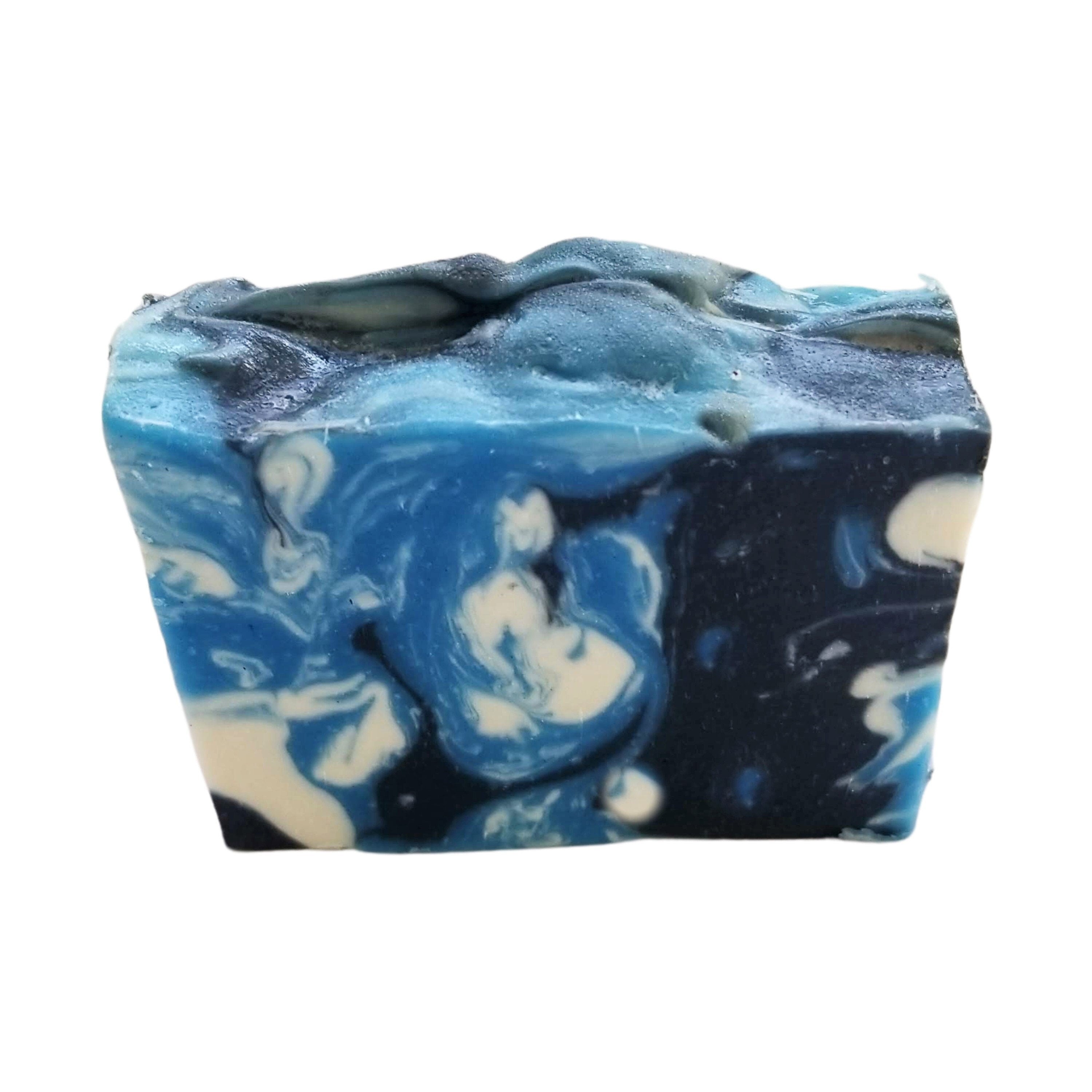 Sandalwood Spirit Soap bar with rich blue swirls, activated charcoal, and kaolin clay, showcasing its unique handcrafted design.