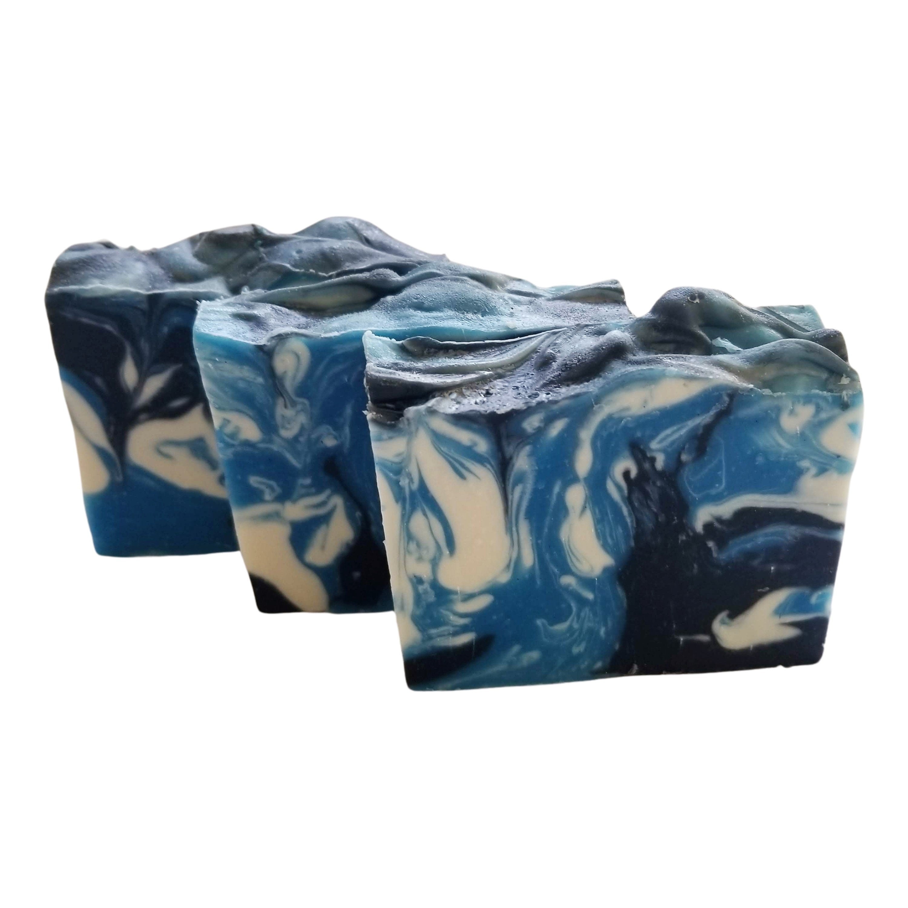 Sandalwood Spirit Soap bar with rich blue swirls, activated charcoal, and kaolin clay, showcasing its unique handcrafted design.