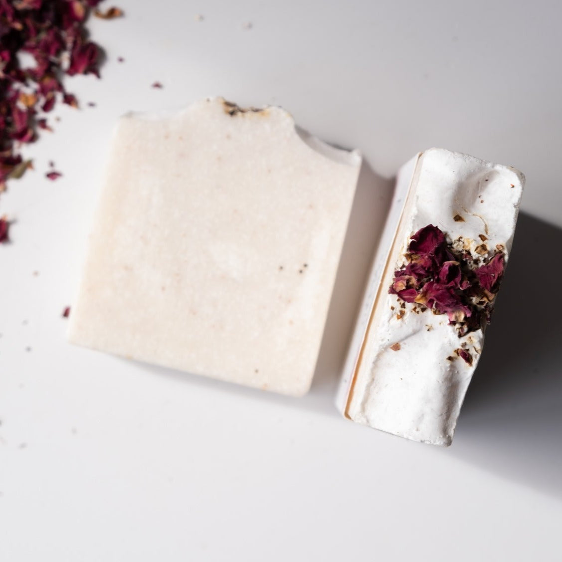 A beautifully crafted Sea Salt Rose Soap Bar with pink hues, showcasing rose petals and a smooth texture, perfect for exfoliating and nourishing the skin.