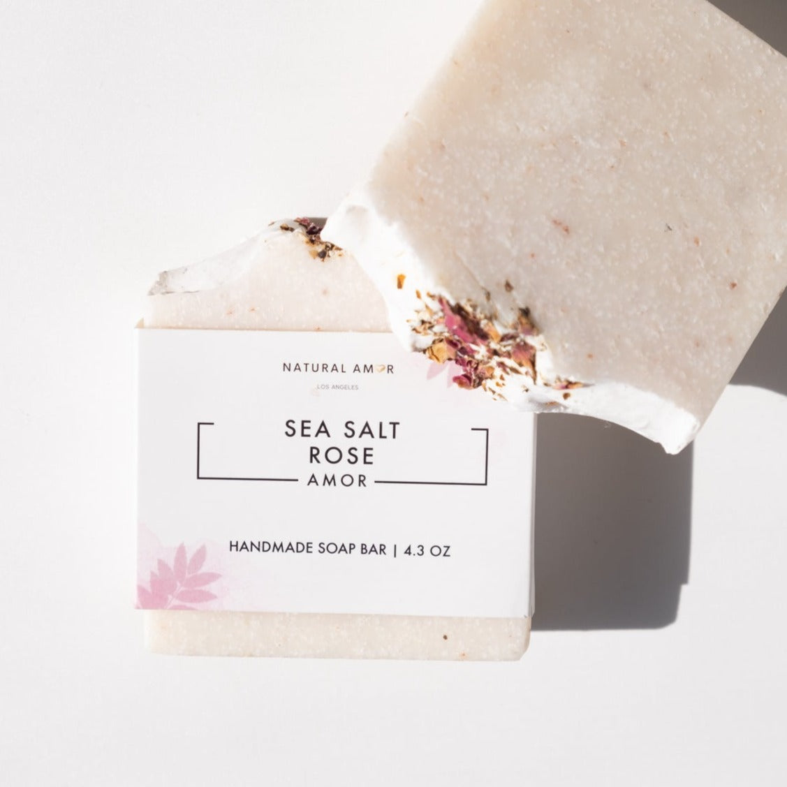 A beautifully crafted Sea Salt Rose Soap Bar with pink hues, showcasing rose petals and a smooth texture, perfect for exfoliating and nourishing the skin.