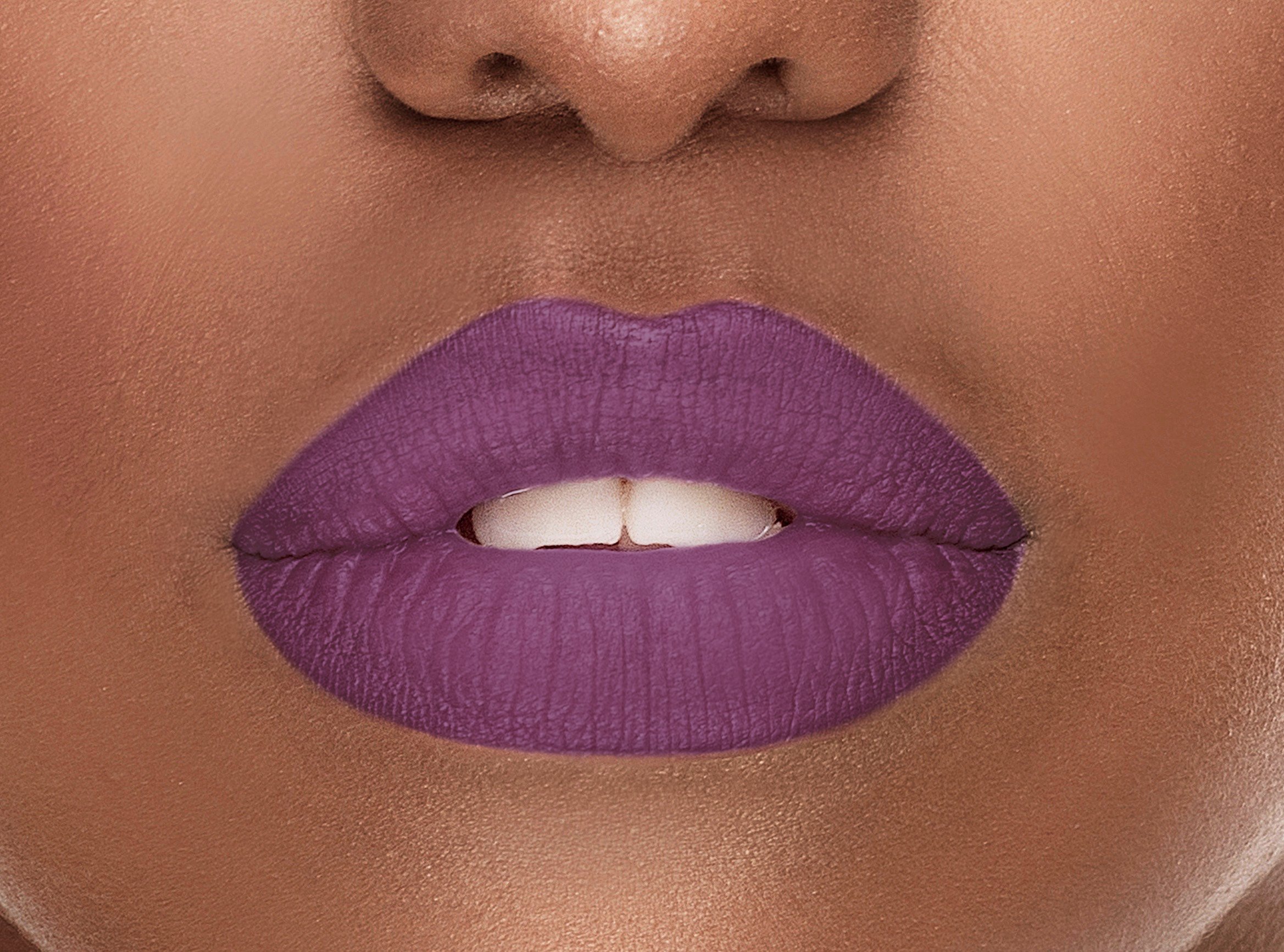 Sensation Silk-Matte Lipstick in Magenta Purple, showcasing its luxurious packaging and vibrant color.