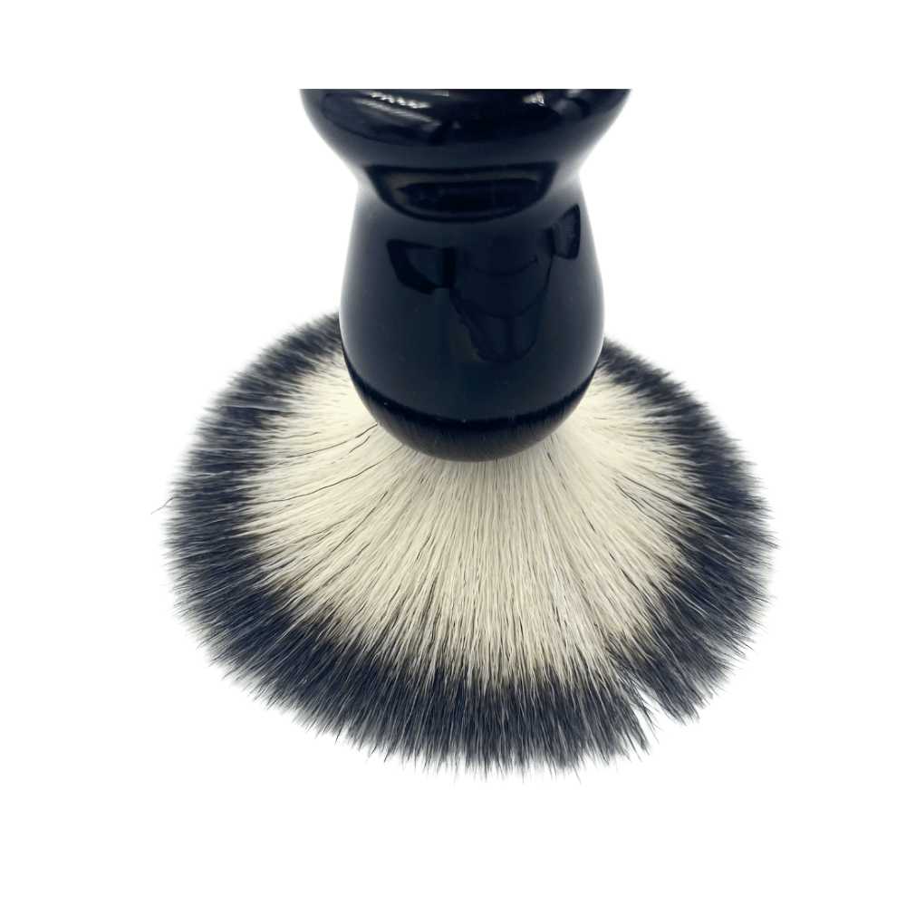 A stylish Shave Brush available in Black, Red, and White, featuring soft vegan bristles for a luxurious shaving experience.