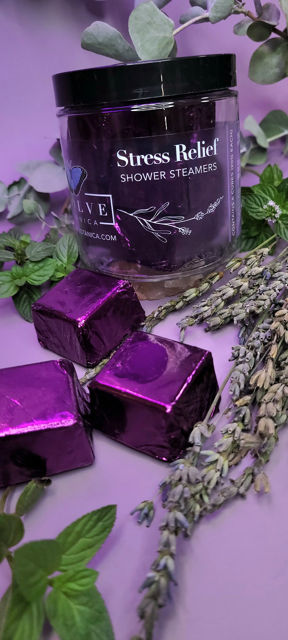 A package of six all-natural shower steamers for stress relief, featuring lavender, peppermint, and eucalyptus essential oils, displayed on a bathroom counter.