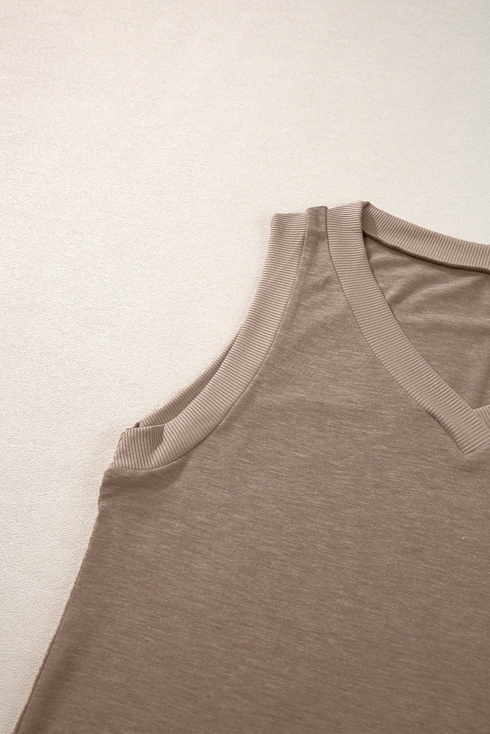 Simply Taupe Ribbed V Neck Tank top displayed on a mannequin, showcasing its stylish design and soft ribbed texture.