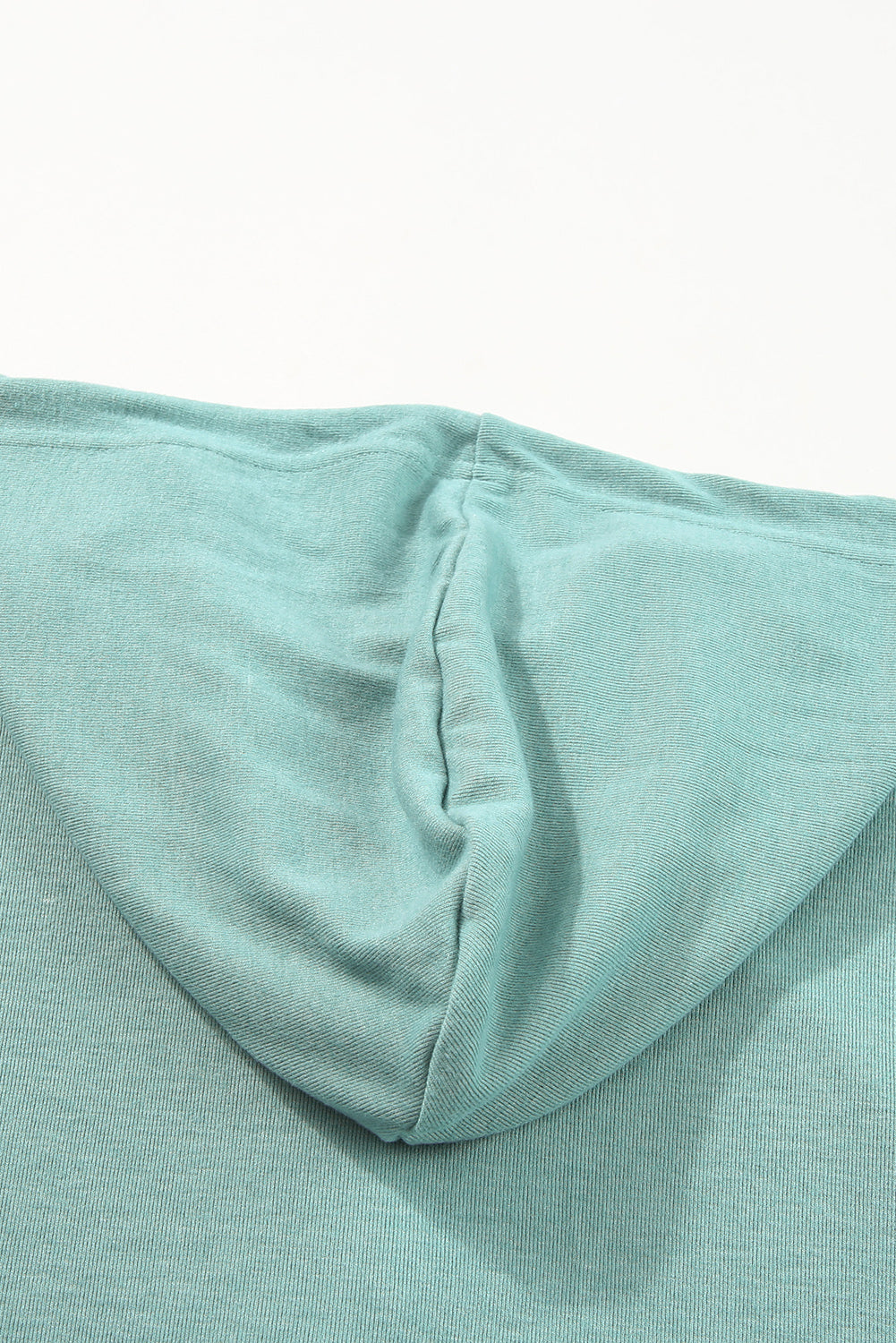 Sky Blue Buttoned High and Low Hem Hoodie with drawstring hood and tortoiseshell buttons, showcasing a relaxed fit and side slits.