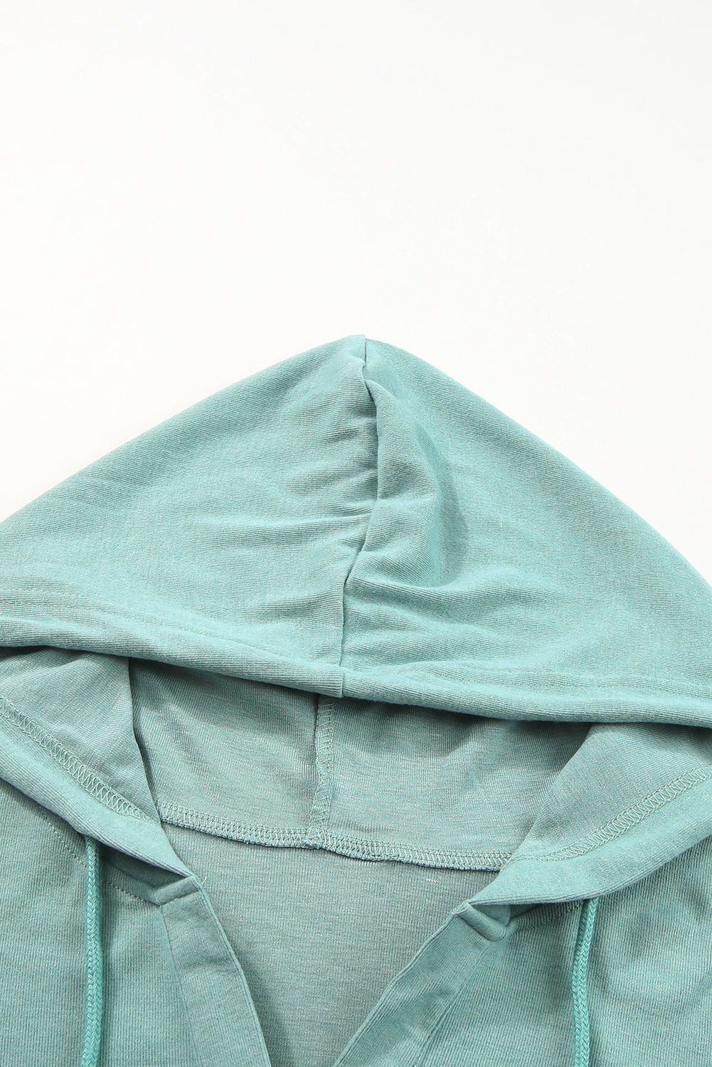 Sky Blue Buttoned High and Low Hem Hoodie with drawstring hood and tortoiseshell buttons, showcasing a relaxed fit and side slits.