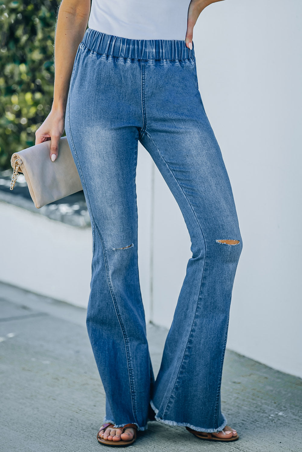 Sky Blue Distressed Bell Bottom Denim Pants featuring an elastic waist, retro bell bottom design, and light distressing details.