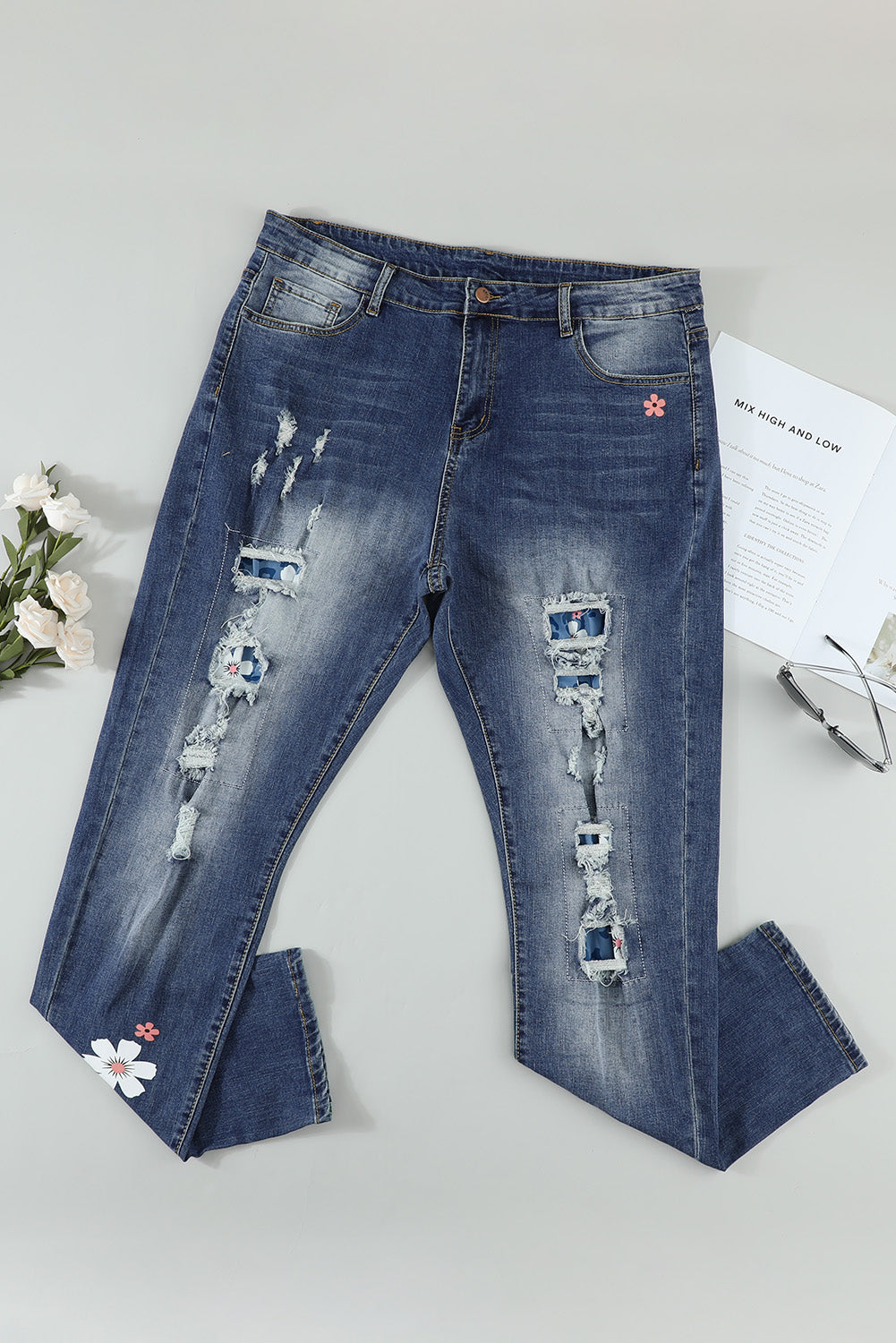 Sky Blue Floral Leopard Print Patchwork Distressed High Waist Jeans showcasing floral and leopard patterns with a trendy distressed look.