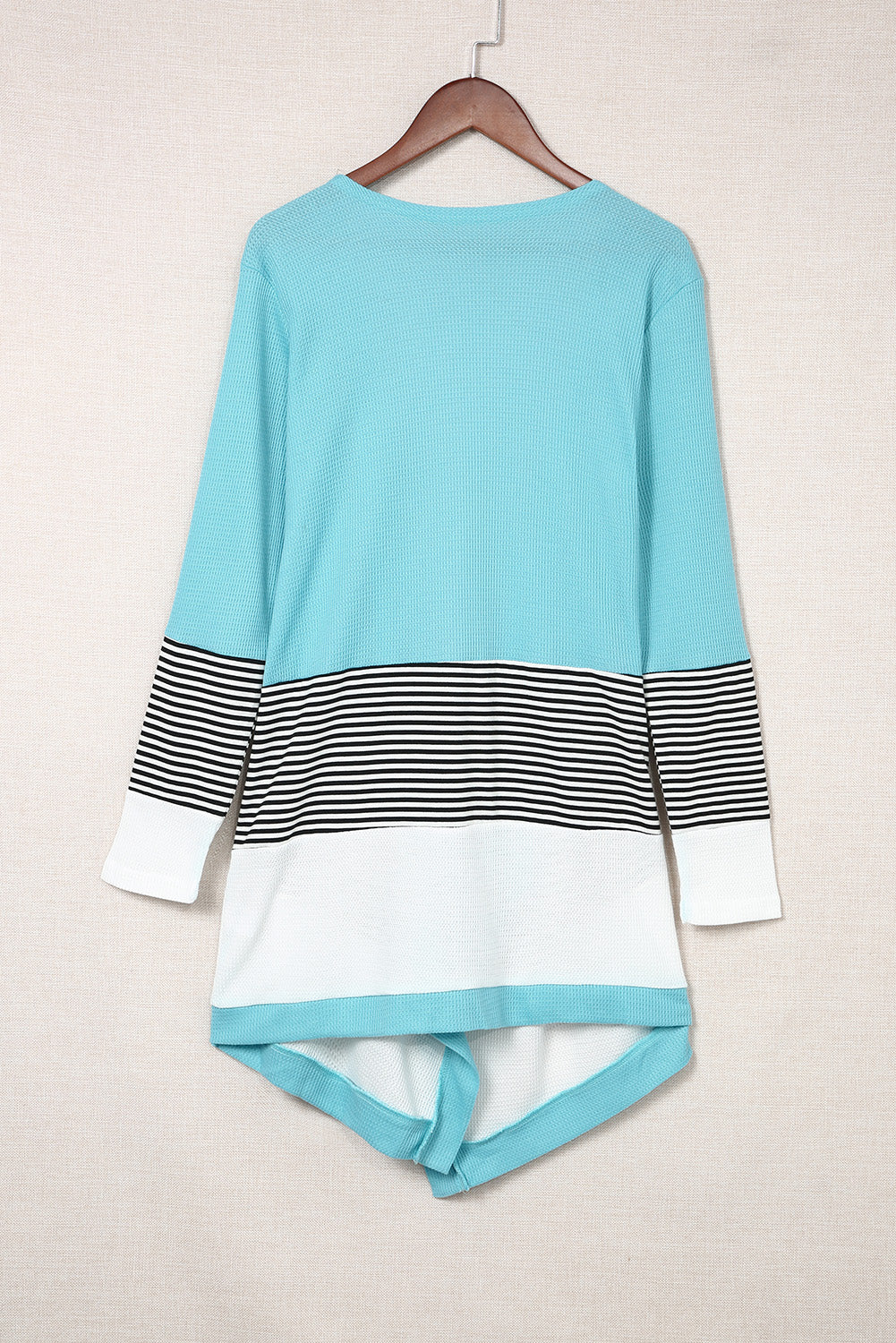 Sky blue loose fit cardigan featuring a striped print and color block design, open front, long sleeves, and an asymmetric hemline.