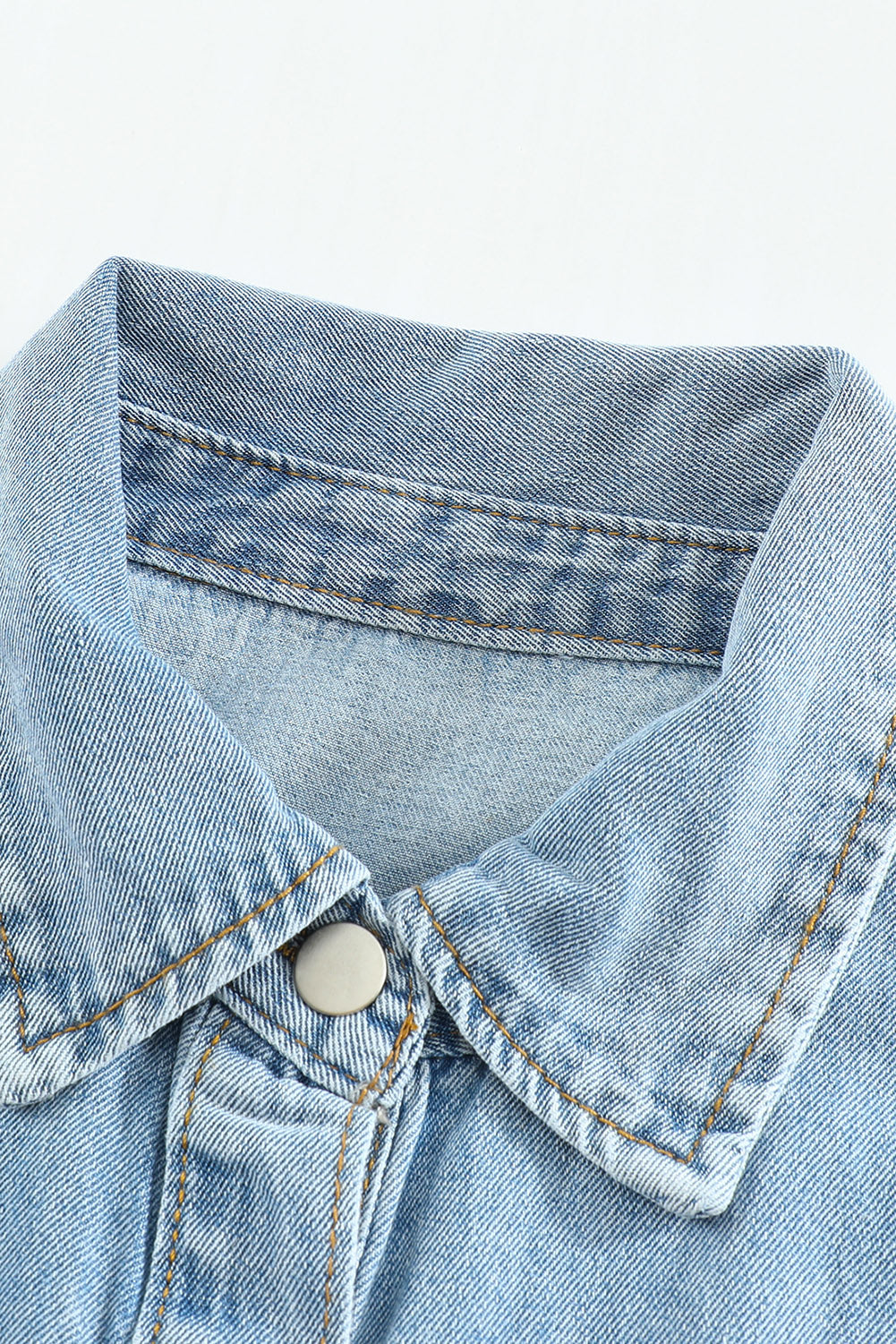 Sky blue denim jacket featuring a raw hem, button closure, and flap pocket, perfect for casual wear.