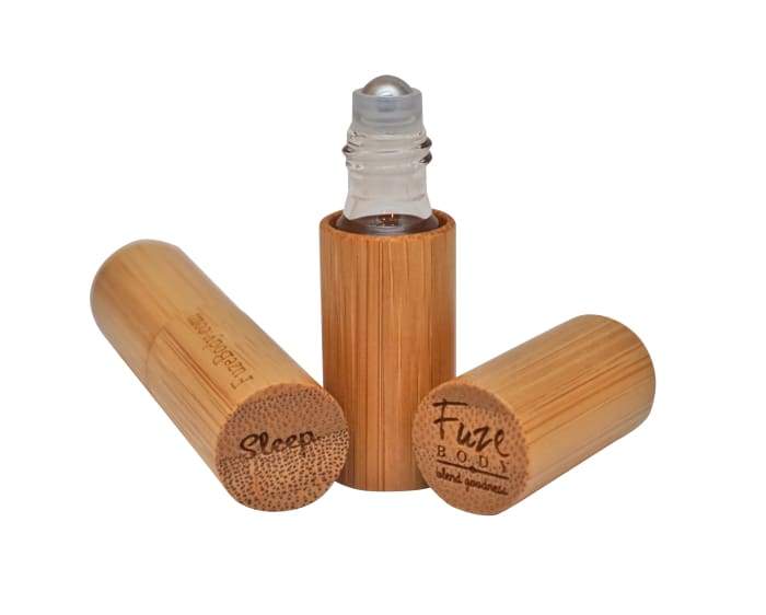 A roll-on bottle of Sleep - Wood Roll-On Pure Essential Oils with a calming design, perfect for promoting restful sleep.