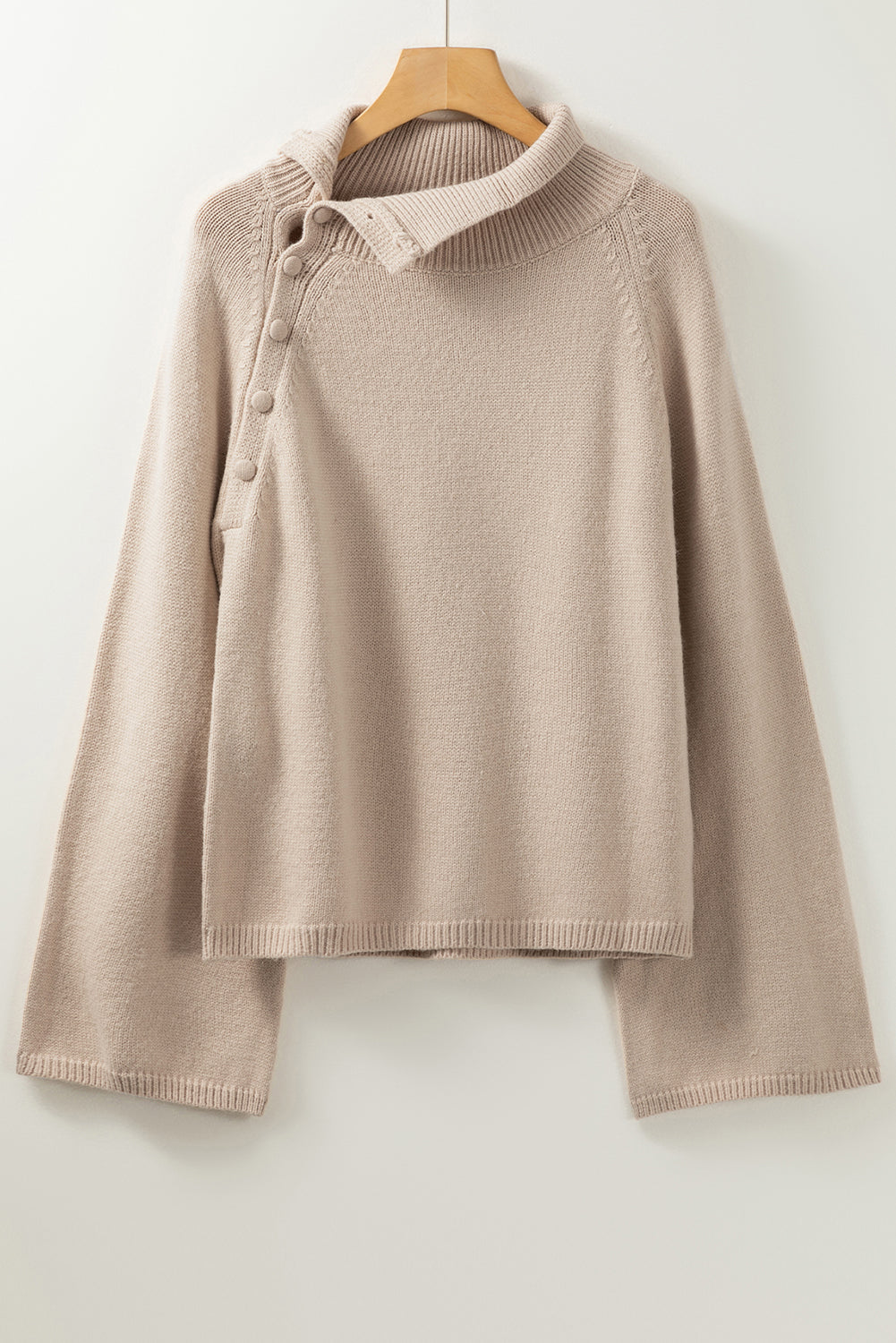 Smoke gray sweater with wide sleeves and high neck, featuring side buttons for adjustable styling.