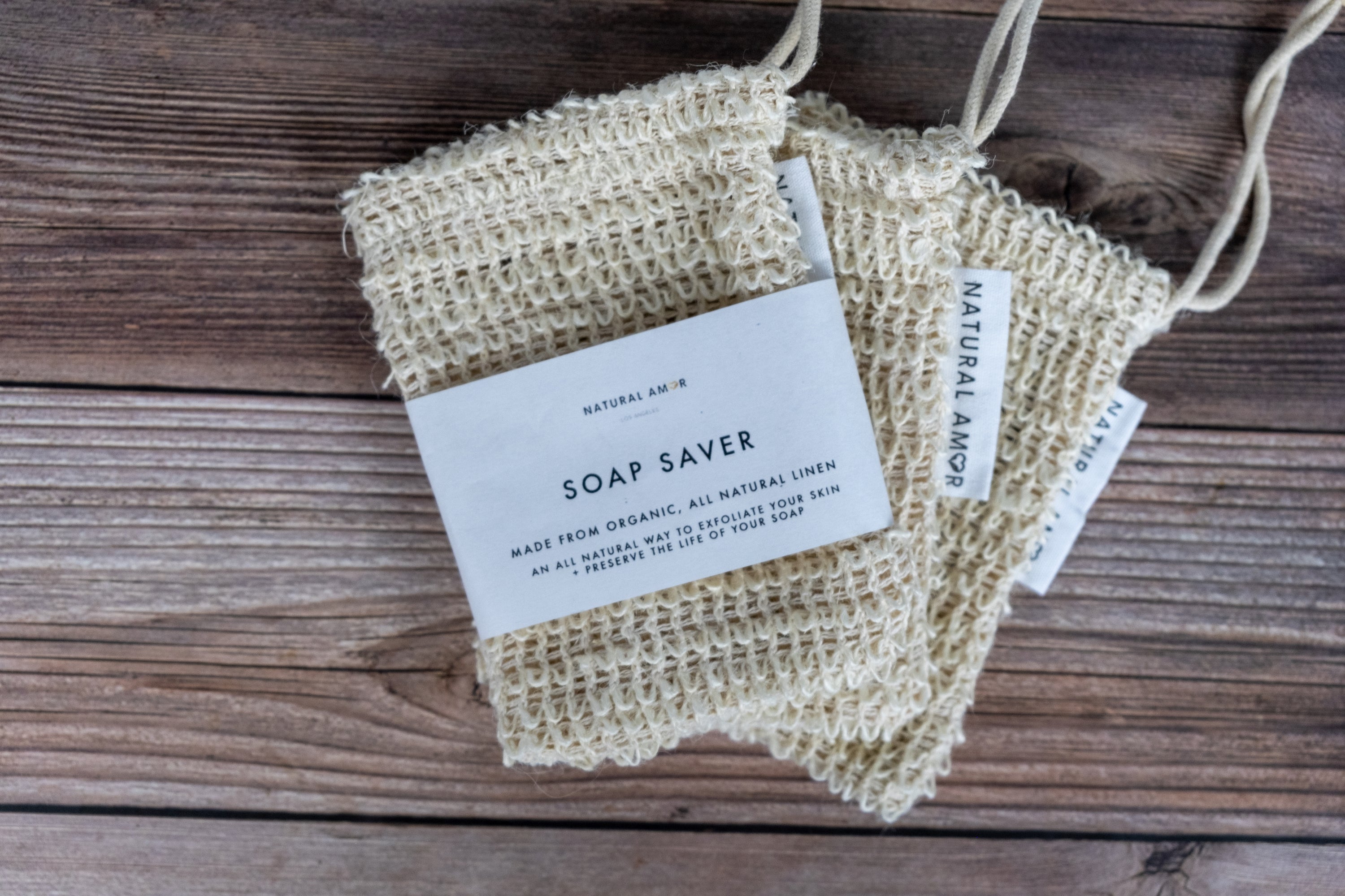 Natural Amor Soap Saver Net made of linen and cotton, designed to hold and dry handmade soap bars, preventing sogginess.