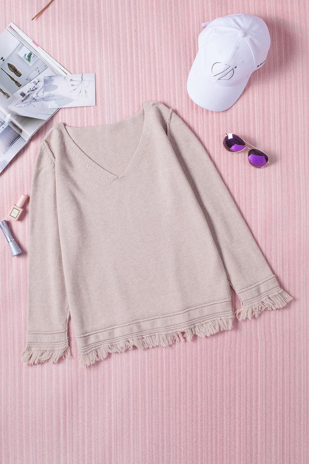 A stylish Solid Color V Neck Tasseled Sweater featuring unique tassels, v-neck design, and a relaxed fit, perfect for casual and formal occasions.