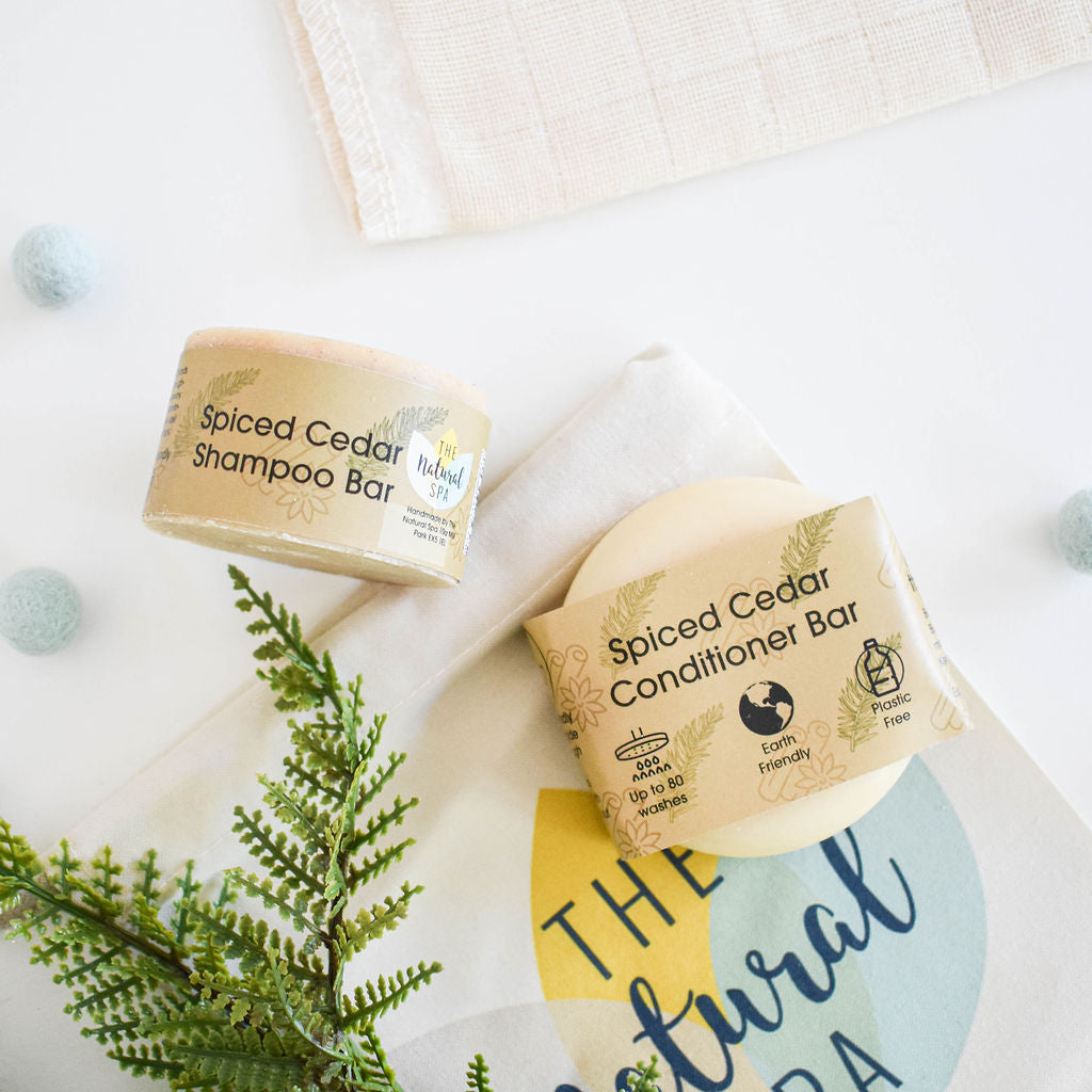 Spiced Cedar Shampoo and Conditioner Bar set featuring eco-friendly solid bars with a natural cedarwood and cinnamon scent.