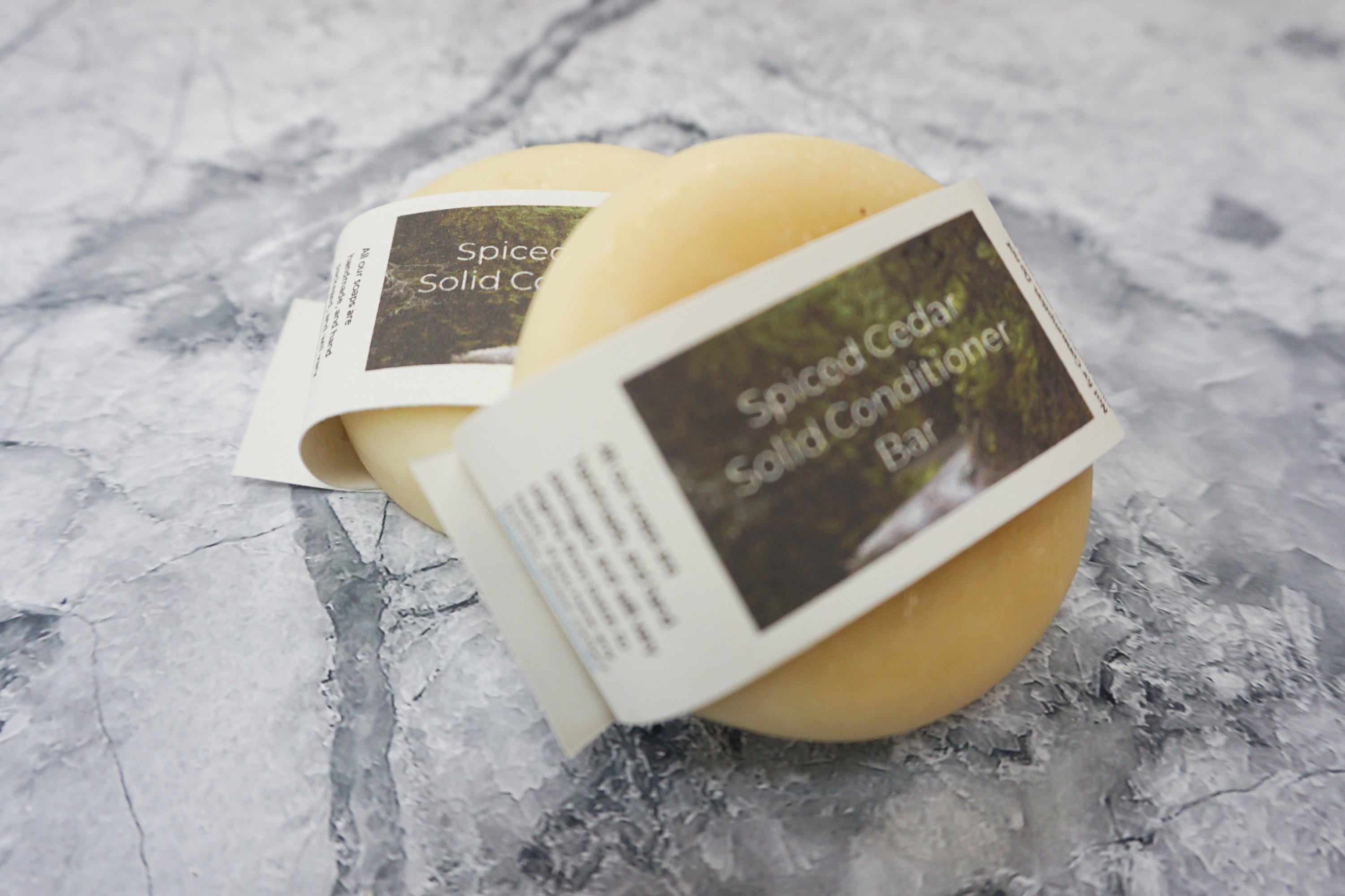 Spiced Cedar Solid Conditioner bar with natural ingredients, showcasing its unique design and eco-friendly packaging.