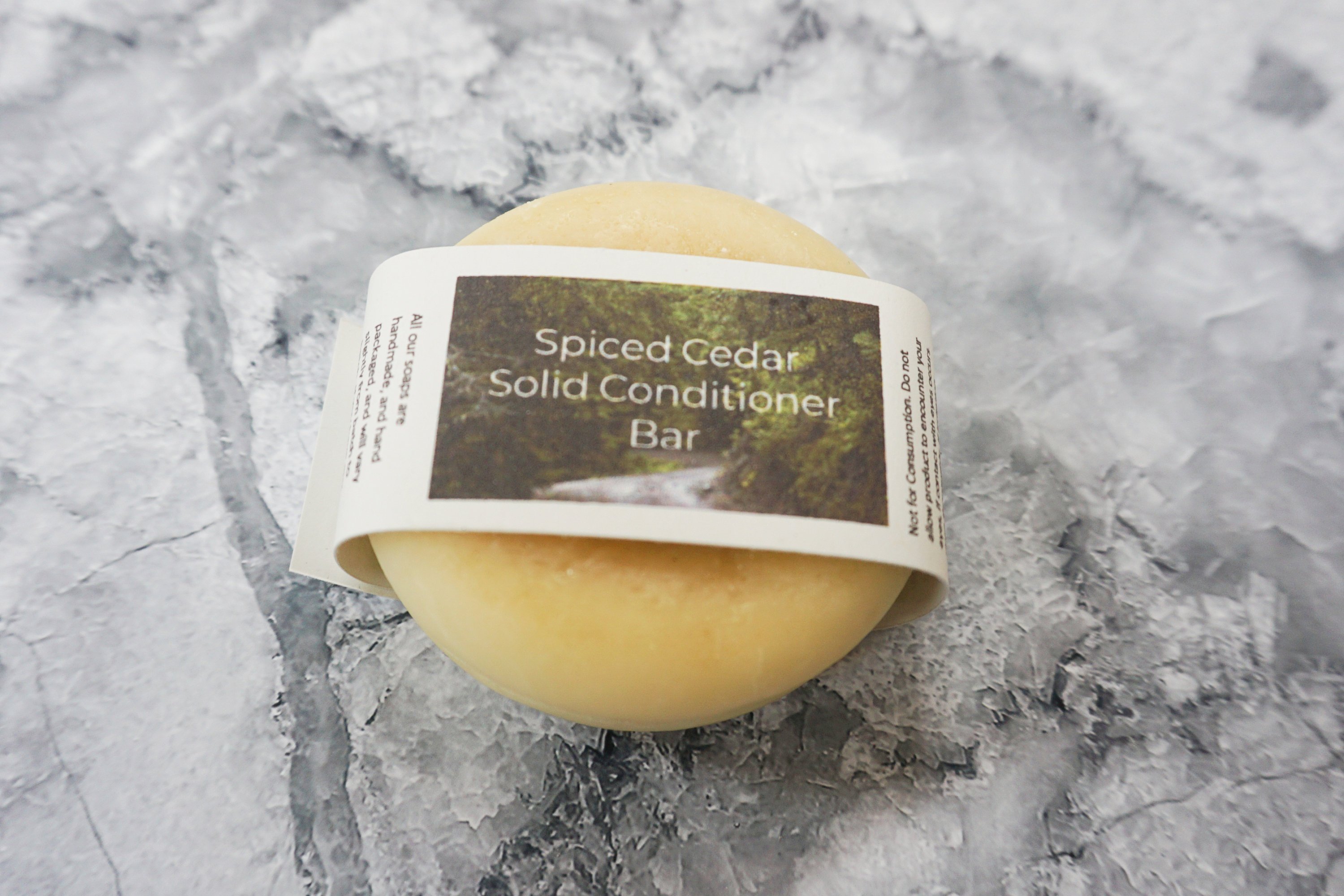 Spiced Cedar Solid Conditioner bar with natural ingredients, showcasing its unique design and eco-friendly packaging.