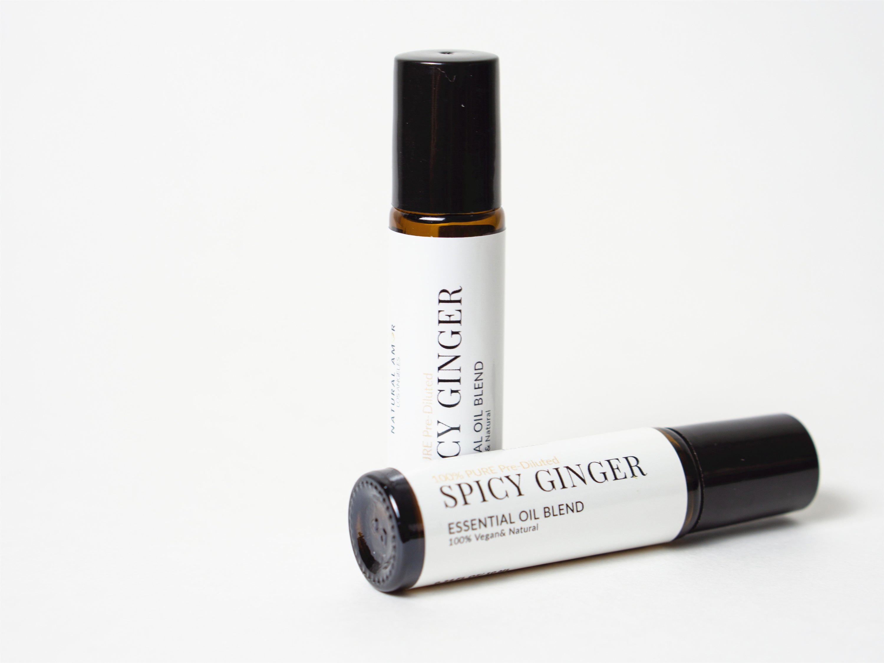 Spicy Ginger Roll On Essential Oil Blend in a 10 mL bottle with a stainless steel rollerball, showcasing its warm and inviting aroma.