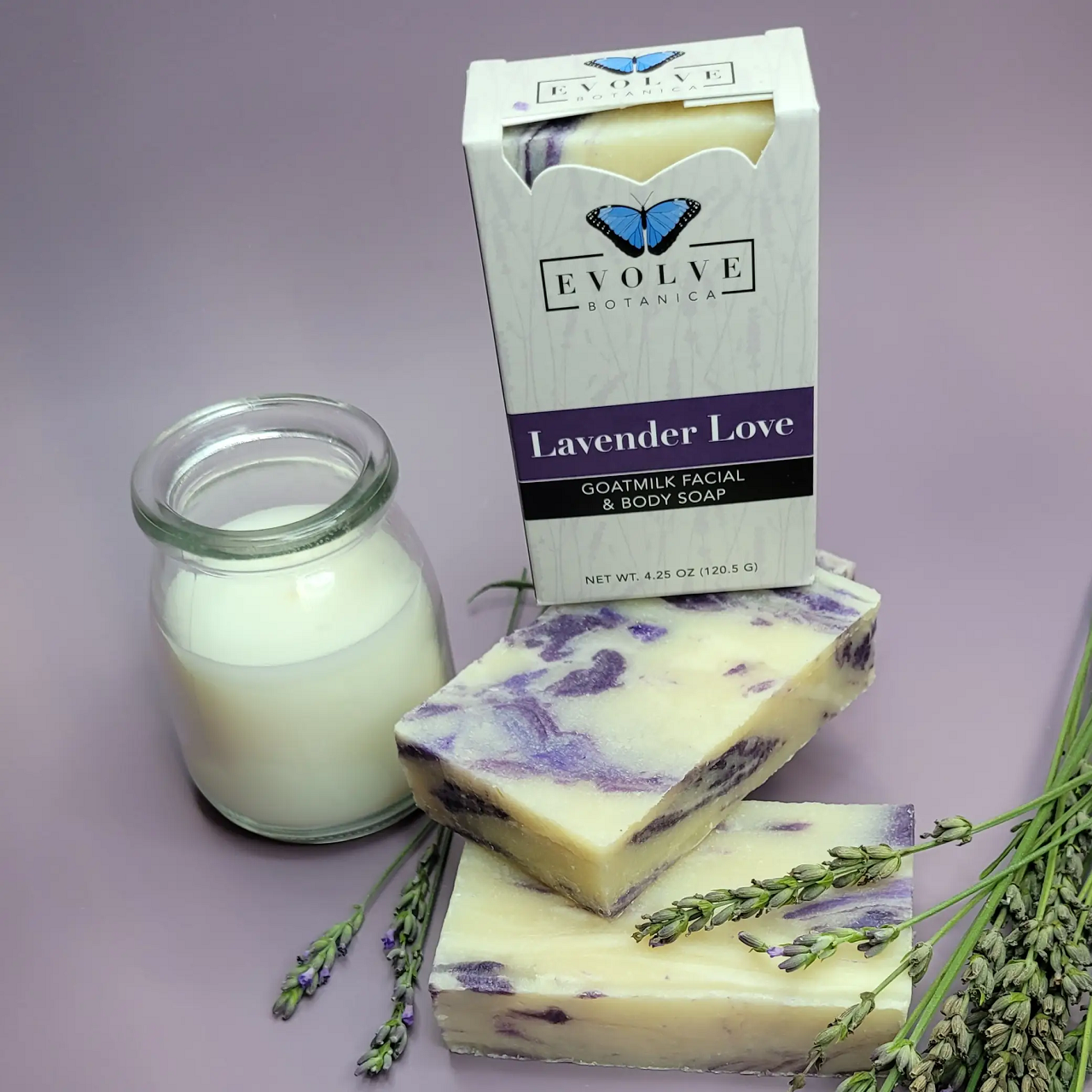 Lavender Love Goatmilk Soap bar with lavender flowers and natural ingredients, showcasing its creamy texture and soothing color.