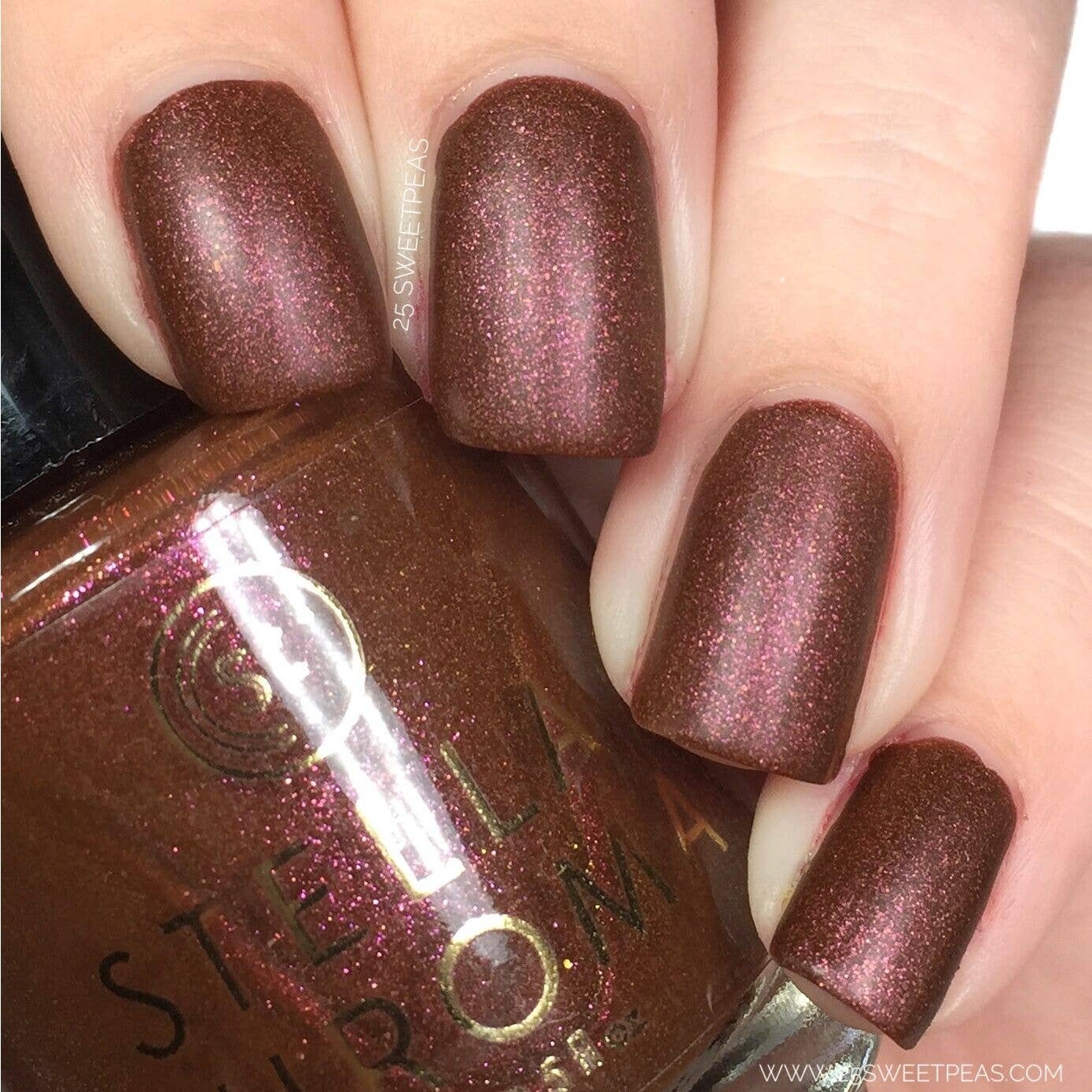 Stella Chroma Nail Polish in Cinnamon & Spice showcasing warm brown tones with pink and orange shimmer in a sleek bottle.