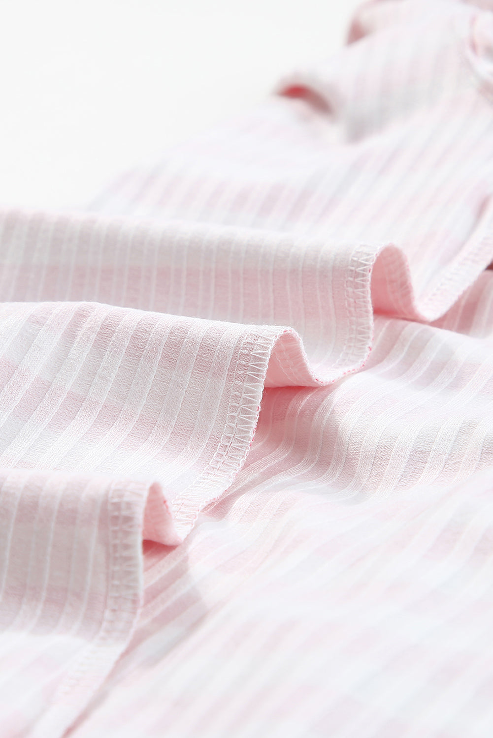 Strawberry pink striped long sleeve tee with textured knit fabric and high neck design, perfect for stylish layering.