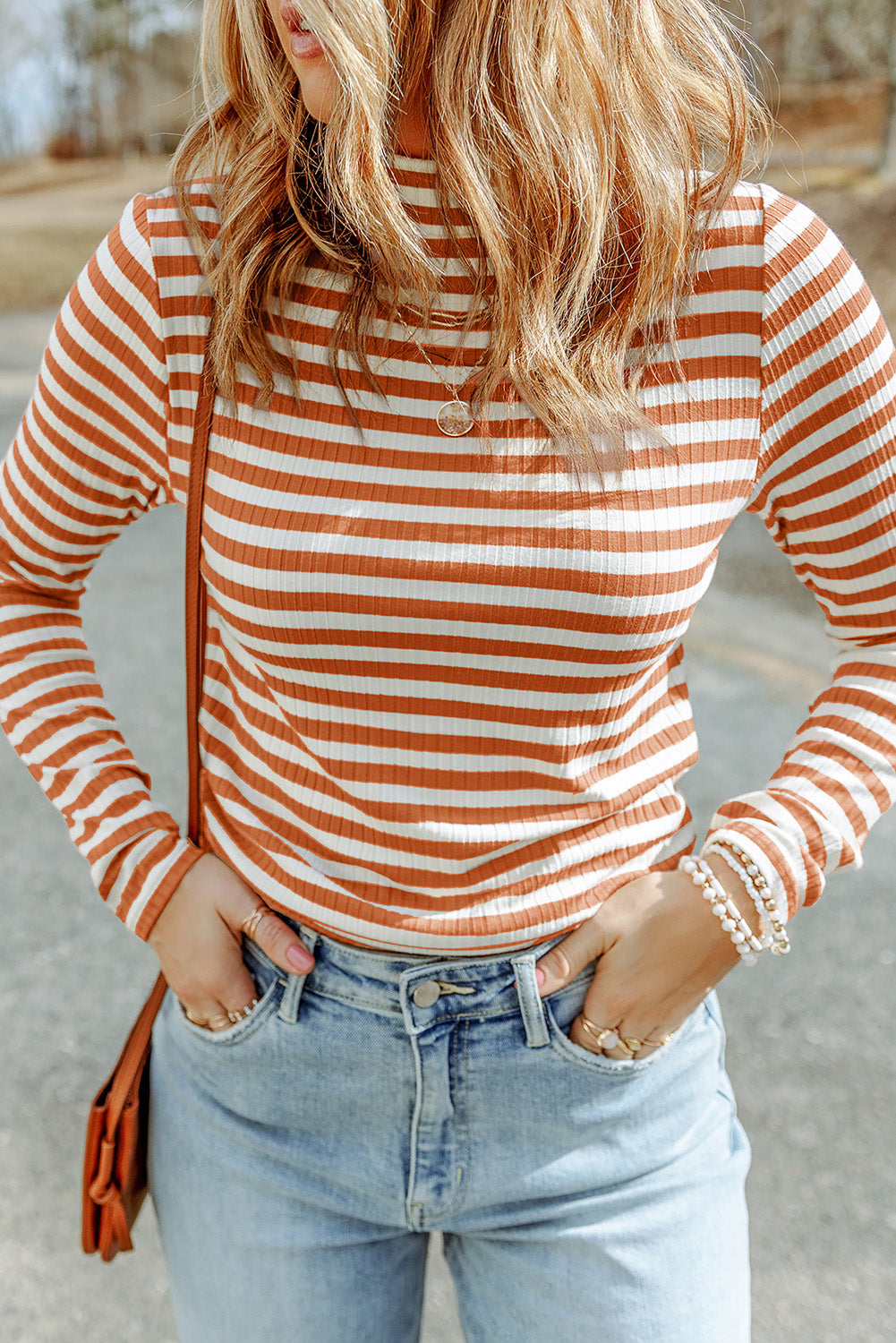 Strawberry pink striped long sleeve tee with textured knit fabric and high neck design, perfect for stylish layering.