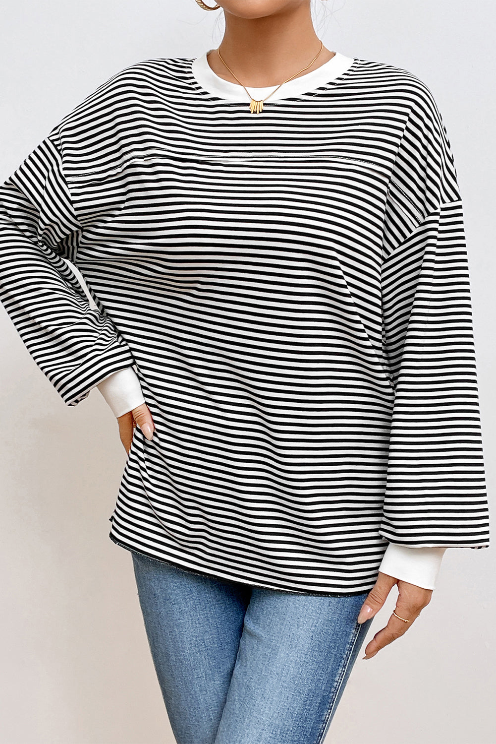 A stylish striped print drop shoulder loose sweatshirt, perfect for casual wear in cooler seasons, featuring long sleeves and a relaxed fit.