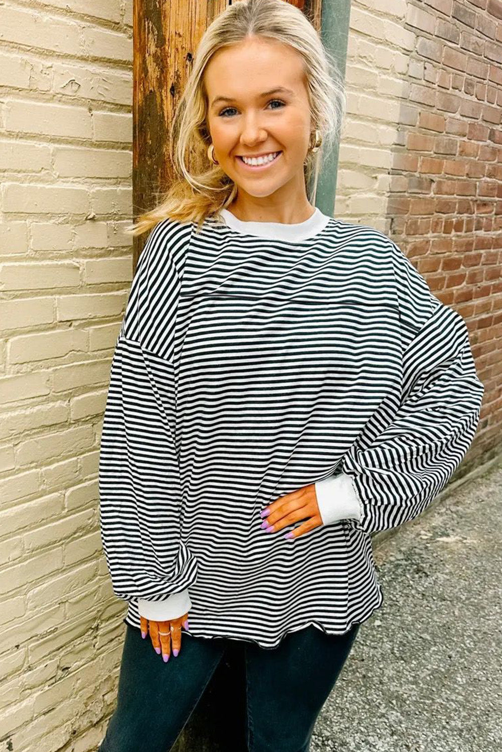 A stylish striped print drop shoulder loose sweatshirt, perfect for casual wear in cooler seasons, featuring long sleeves and a relaxed fit.