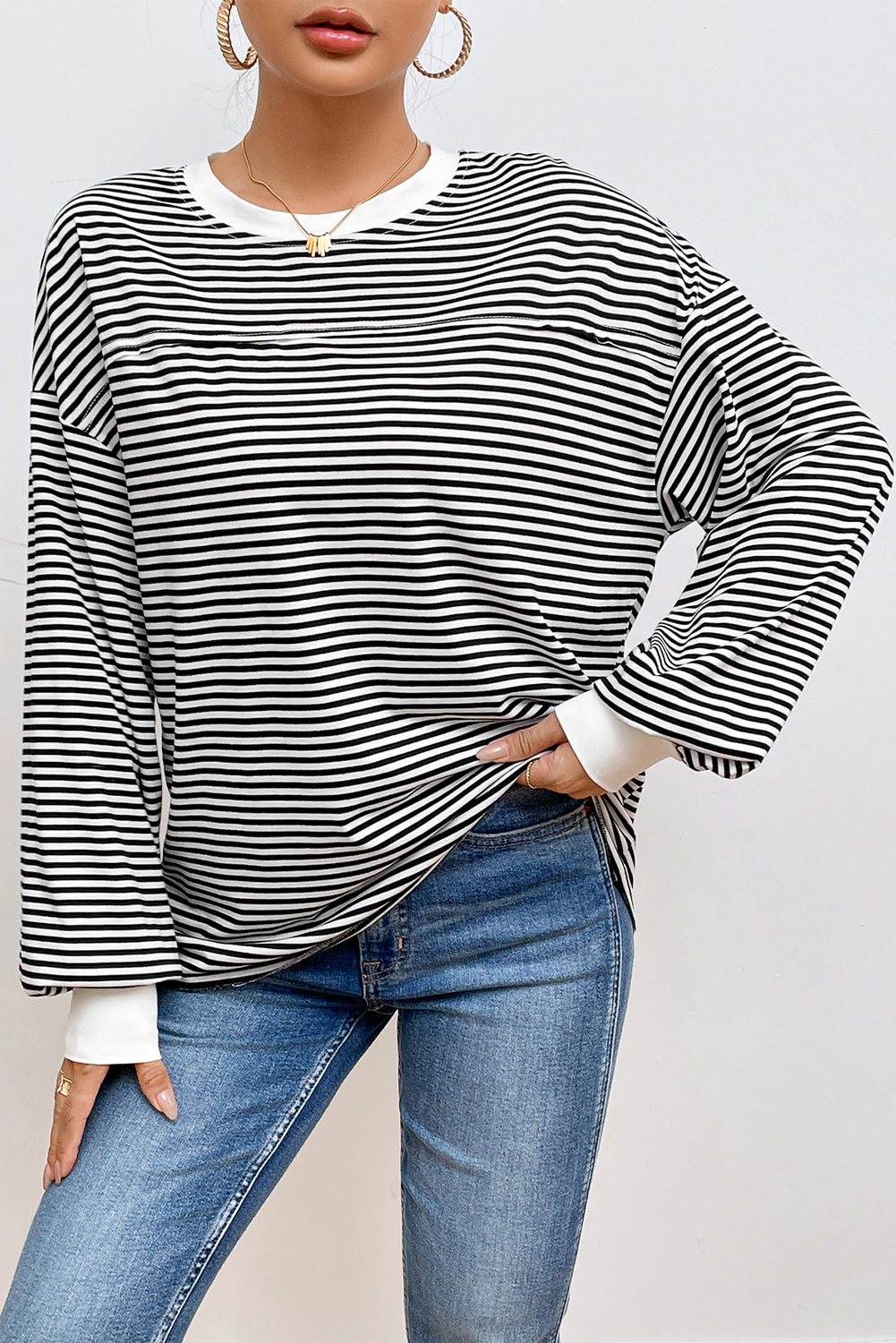 A stylish striped print drop shoulder loose sweatshirt, perfect for casual wear in cooler seasons, featuring long sleeves and a relaxed fit.