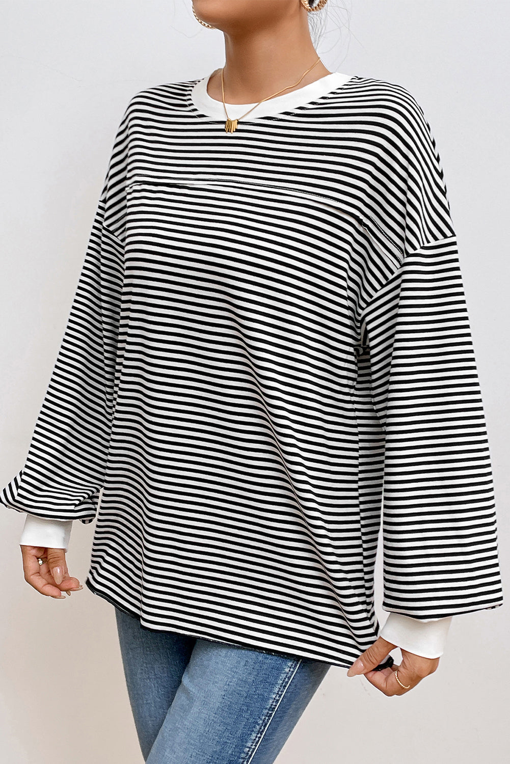 A stylish striped print drop shoulder loose sweatshirt, perfect for casual wear in cooler seasons, featuring long sleeves and a relaxed fit.