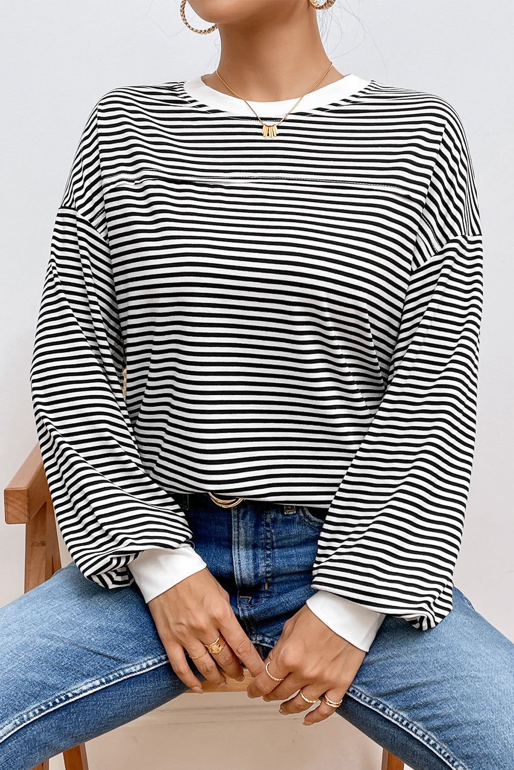 A stylish striped print drop shoulder loose sweatshirt, perfect for casual wear in cooler seasons, featuring long sleeves and a relaxed fit.