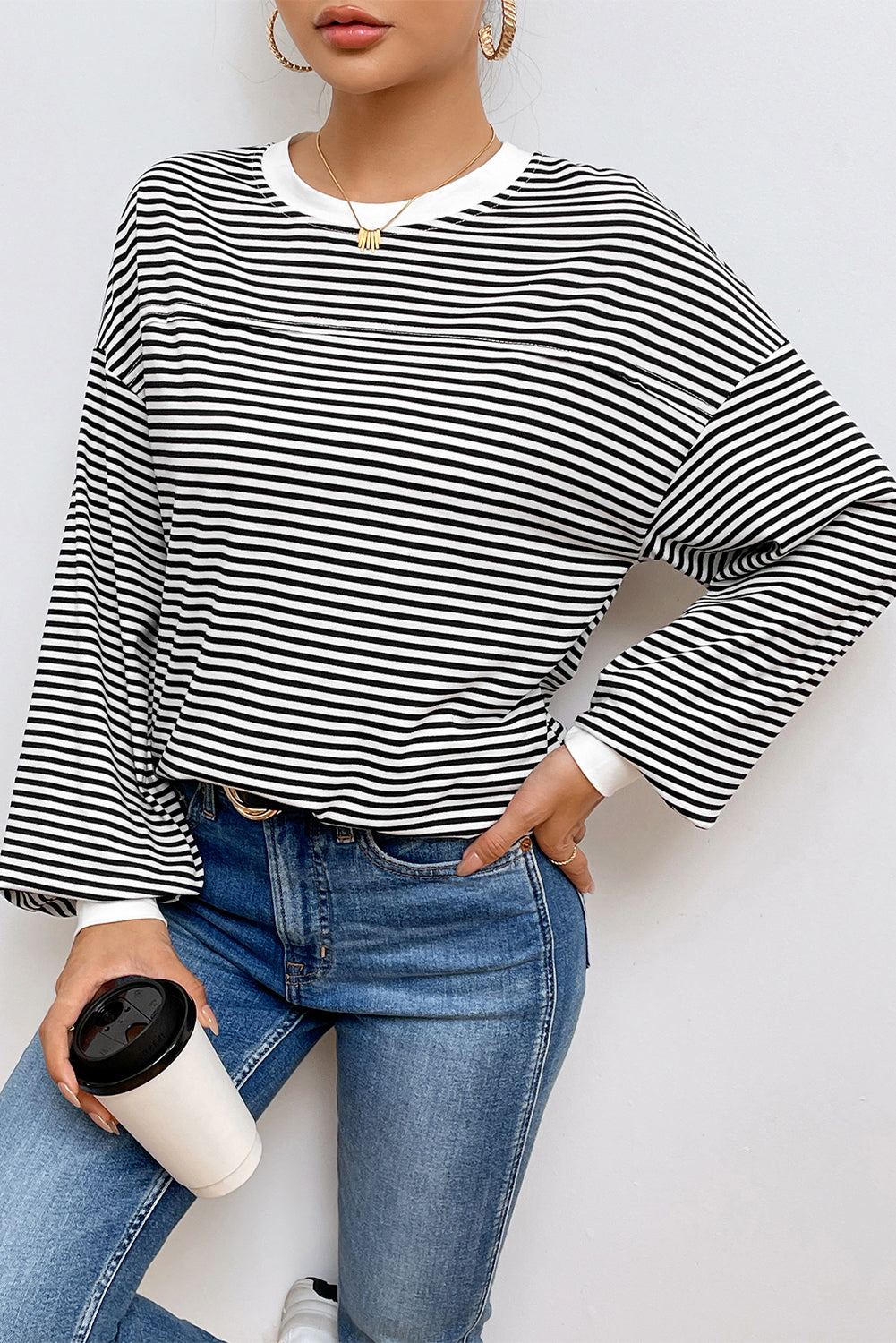 A stylish striped print drop shoulder loose sweatshirt, perfect for casual wear in cooler seasons, featuring long sleeves and a relaxed fit.