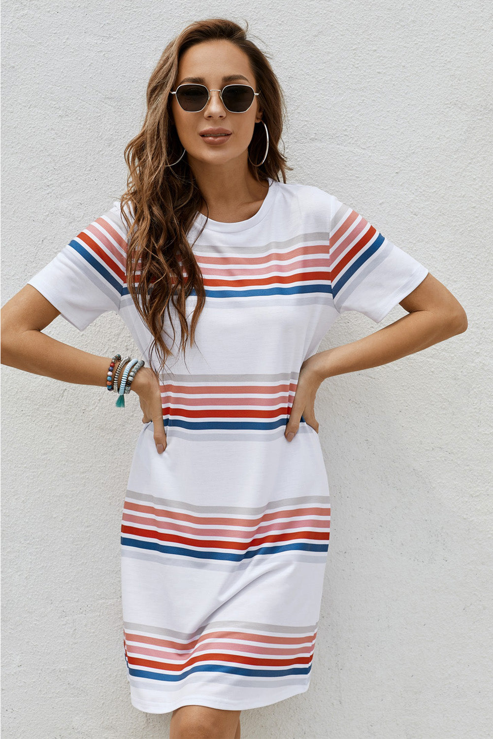 A stylish striped print round neck t-shirt mini dress displayed on a mannequin, showcasing its casual and chic design.