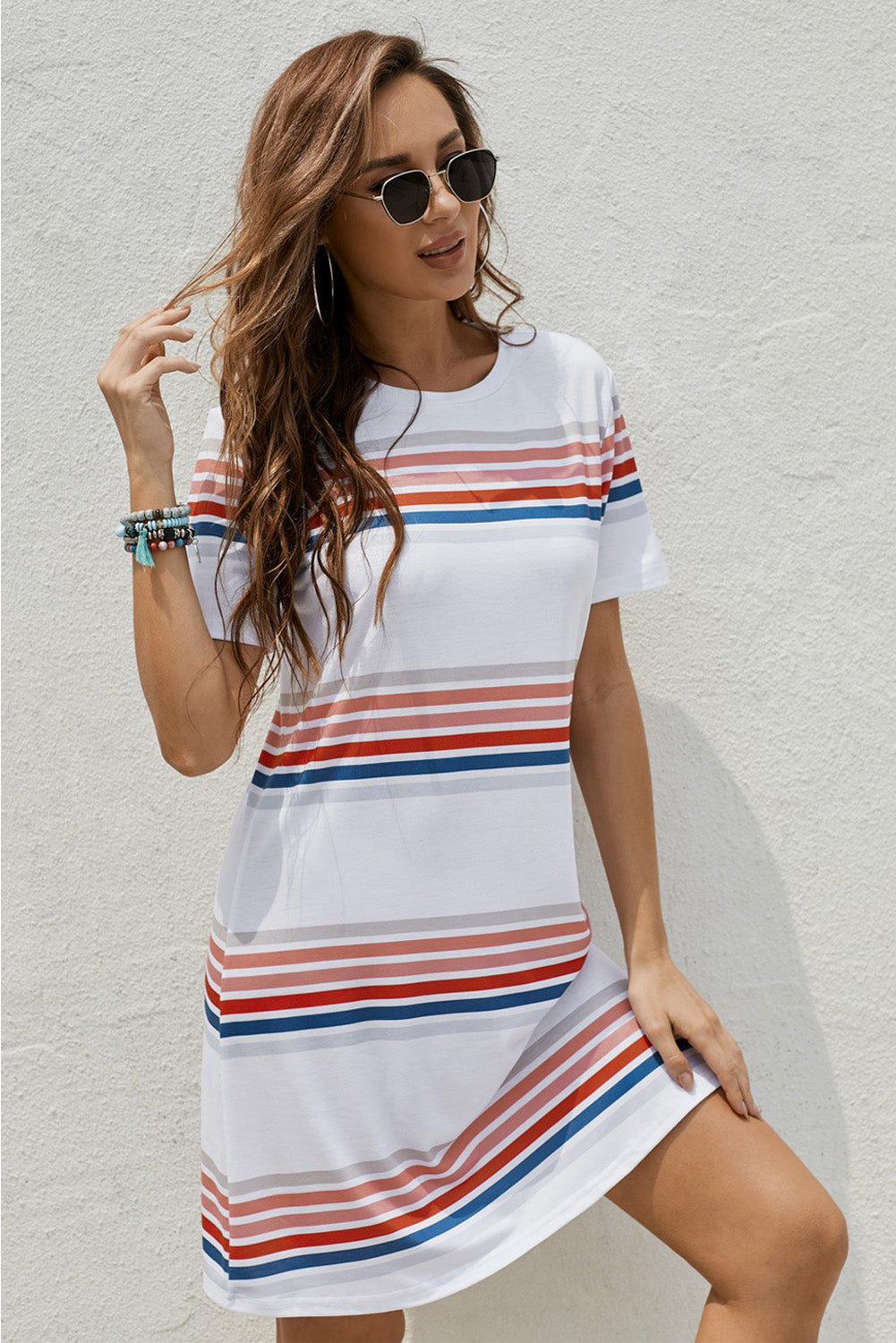 A stylish striped print round neck t-shirt mini dress displayed on a mannequin, showcasing its casual and chic design.