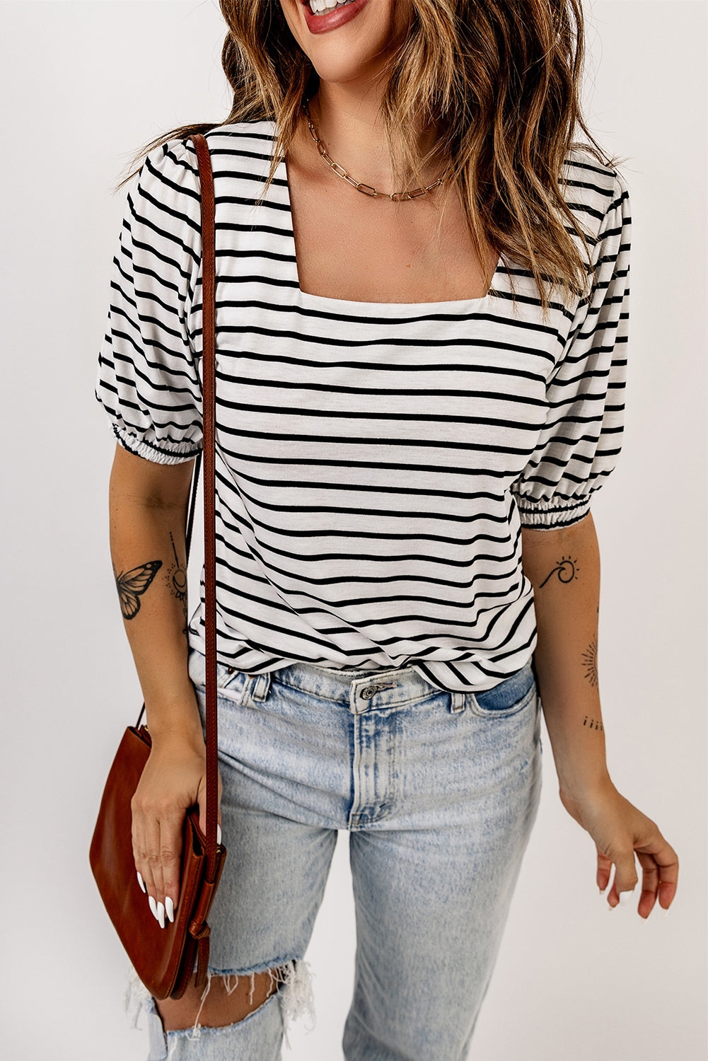 A stylish striped puff sleeve top featuring a square neckline and relaxed fit, perfect for casual outings.