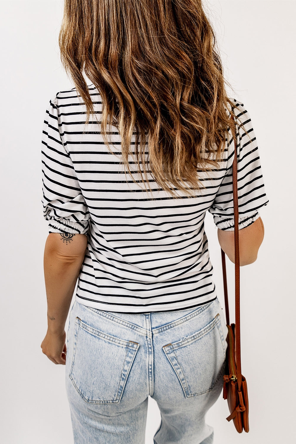 A stylish striped puff sleeve top featuring a square neckline and relaxed fit, perfect for casual outings.