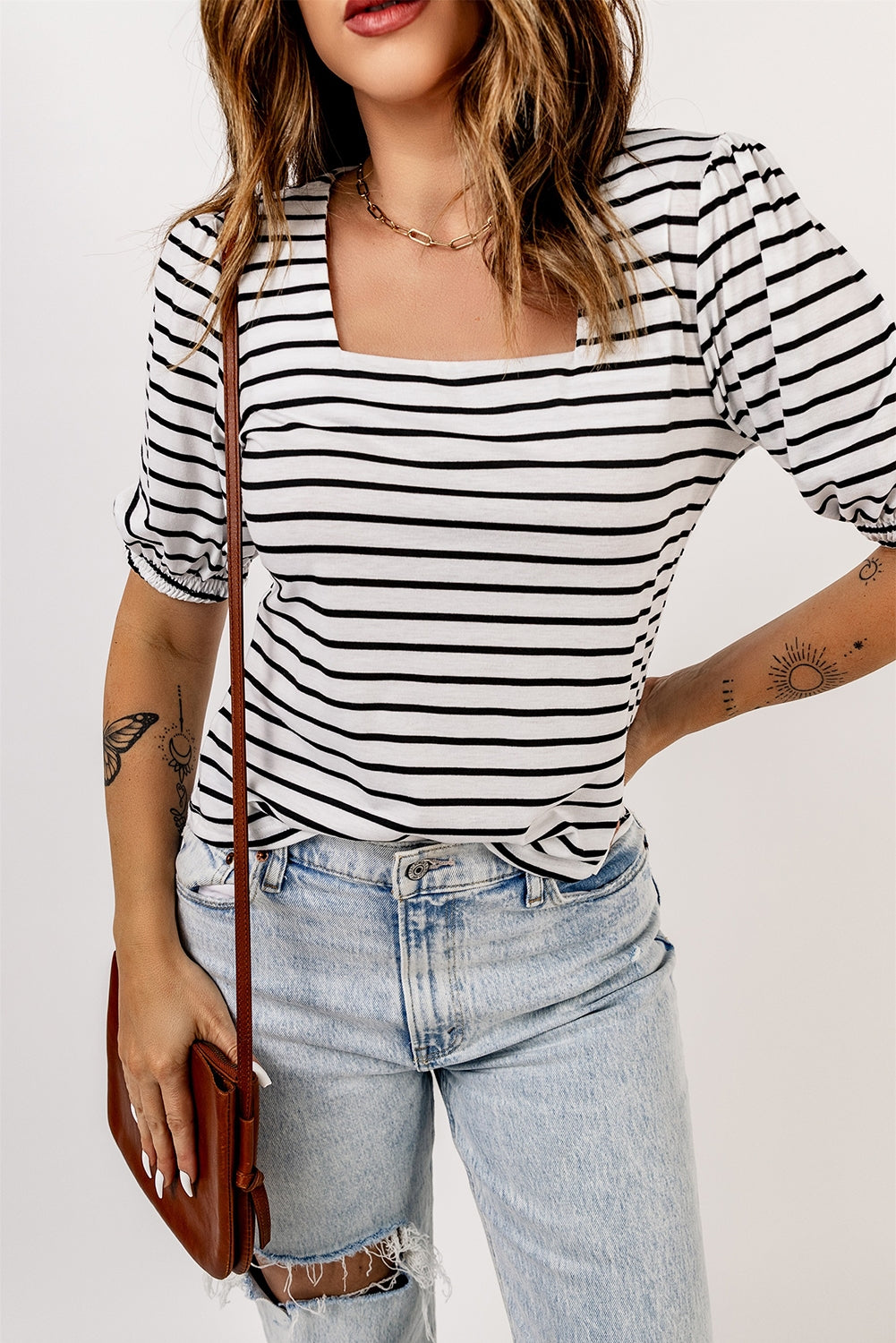 A stylish striped puff sleeve top featuring a square neckline and relaxed fit, perfect for casual outings.