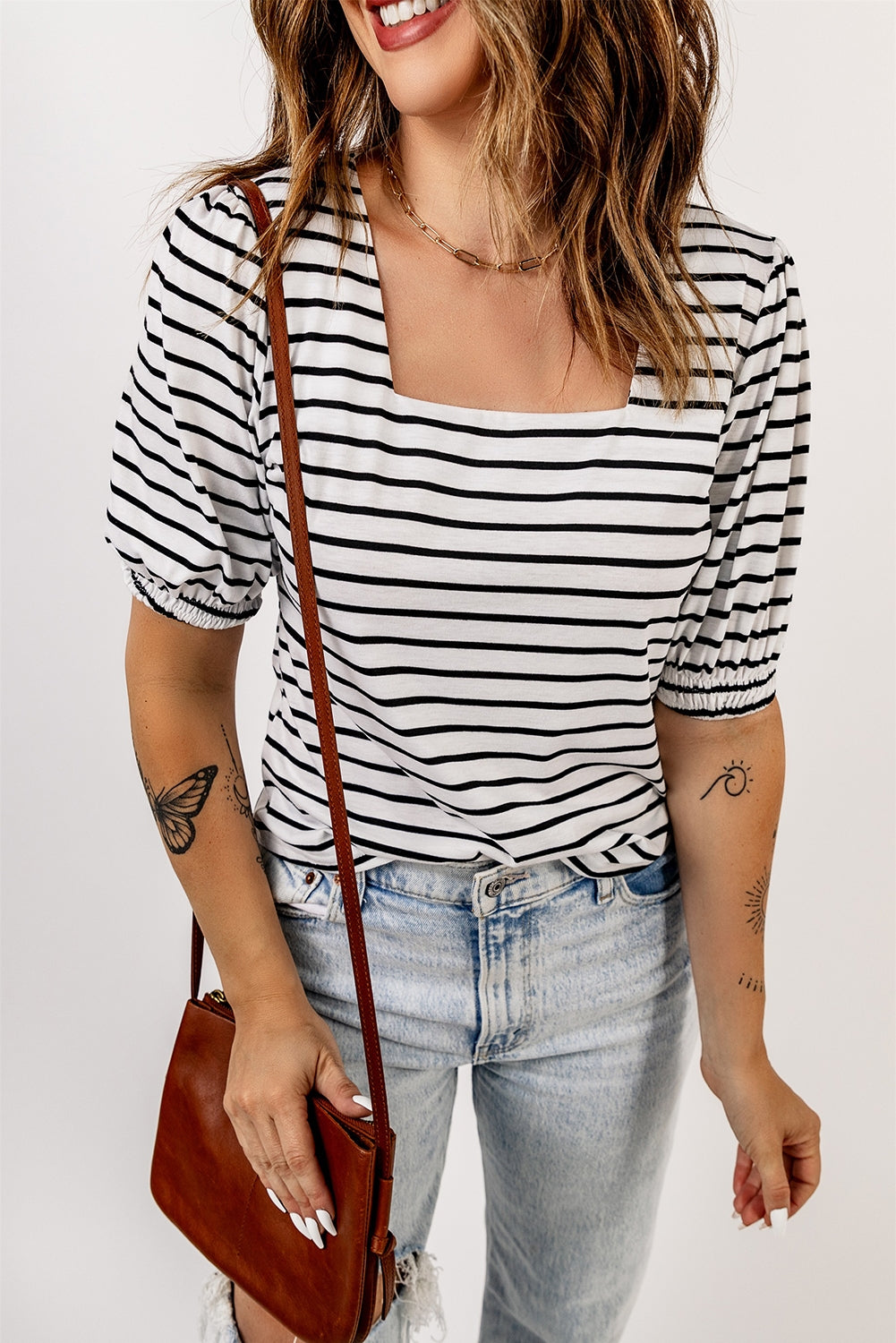 A stylish striped puff sleeve top featuring a square neckline and relaxed fit, perfect for casual outings.