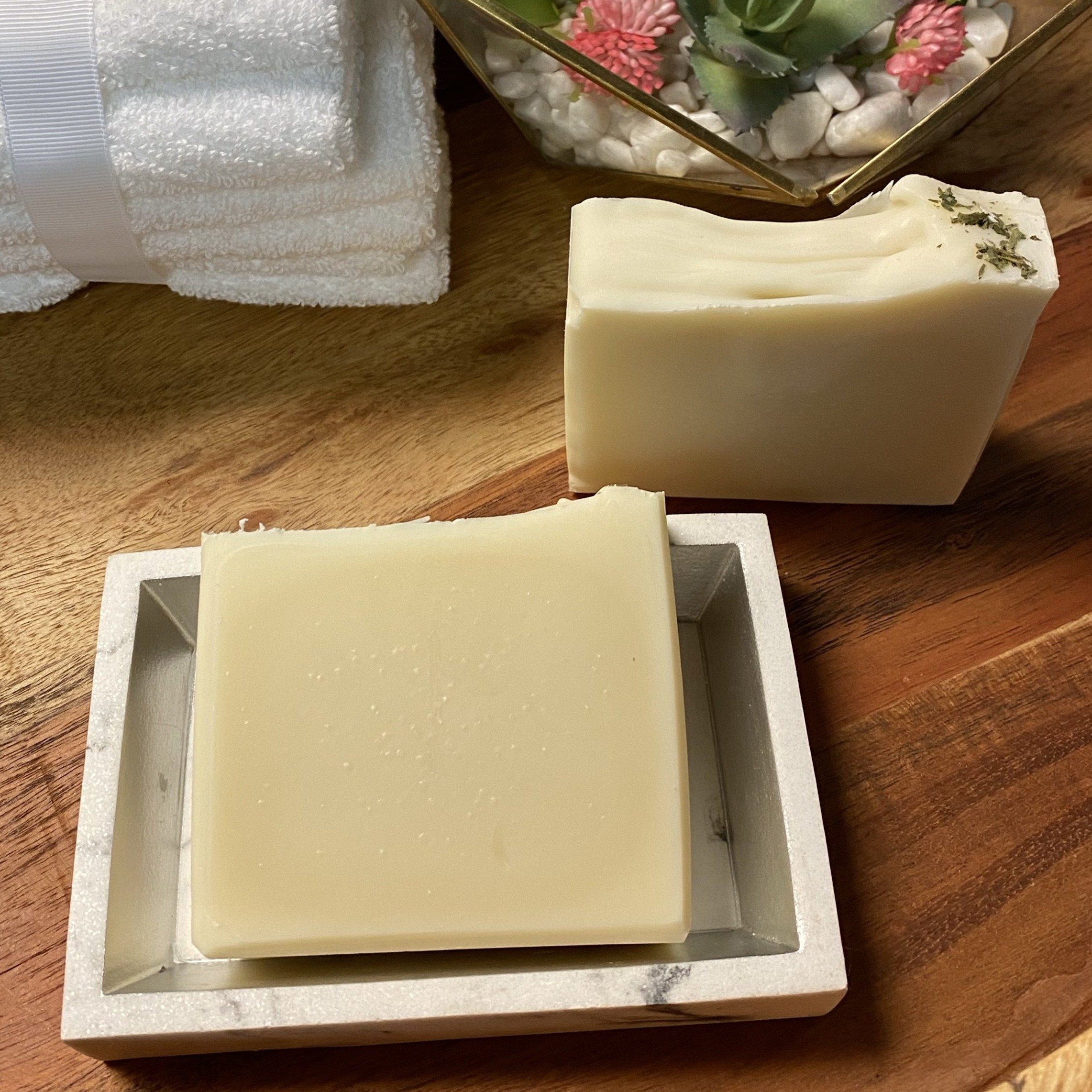 Tee Tree Shampoo Bar Soap with mint leaves, showcasing its creamy texture and natural ingredients.