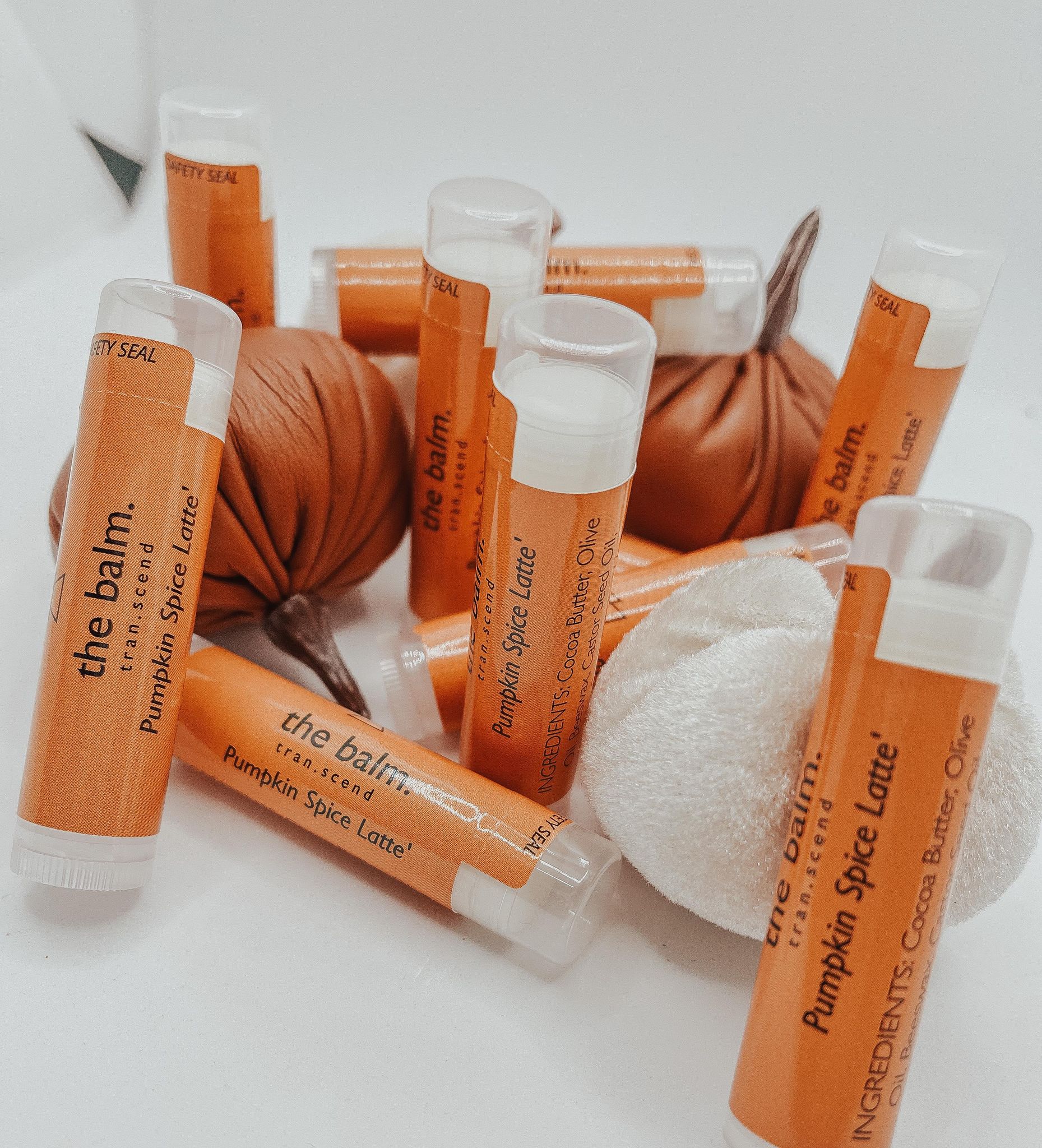 The Balm - Pumpkin Spice Latte lip balm in a stylish tube, showcasing its warm autumn-inspired design and inviting pumpkin spice scent.