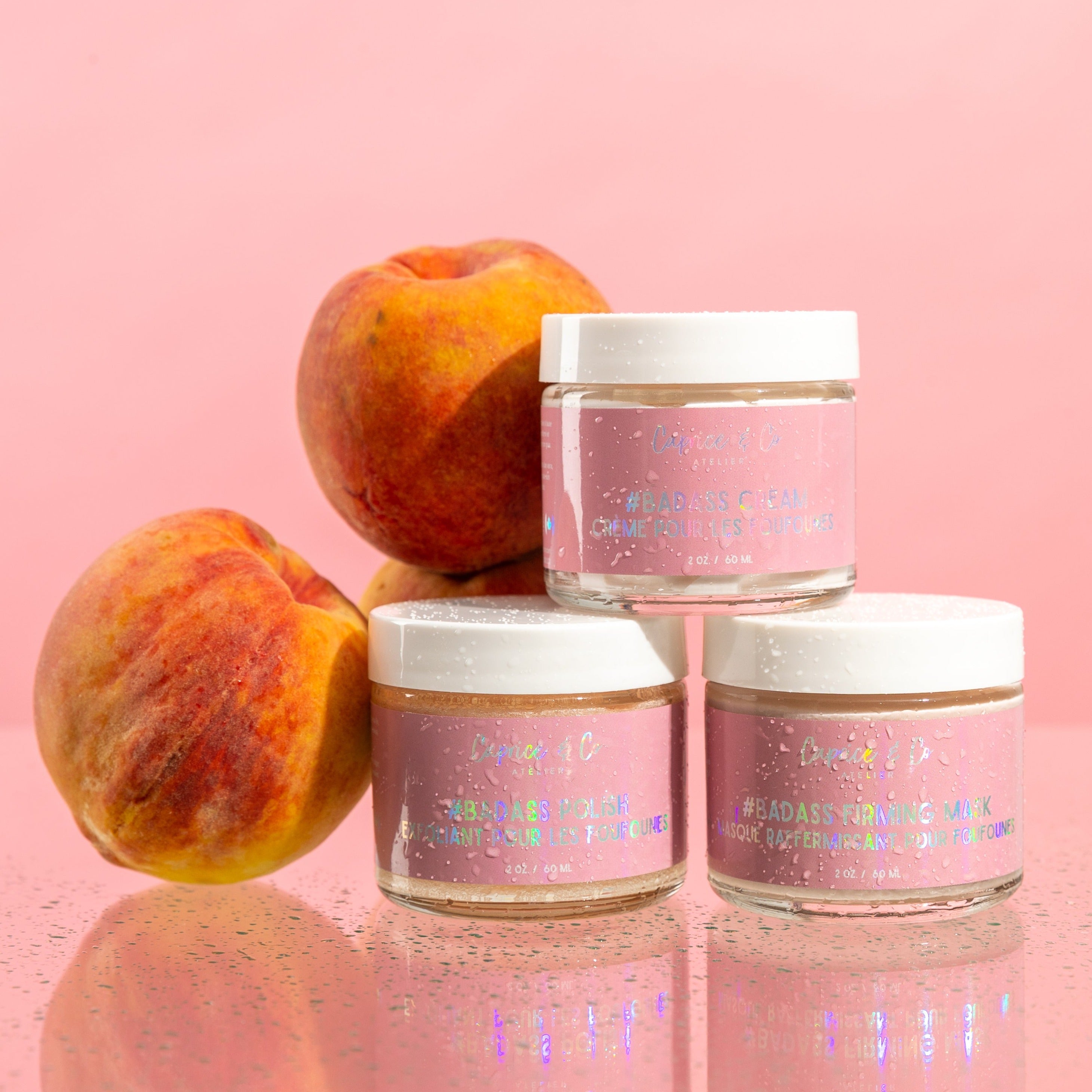 The Booty Care trio featuring scrub, mask, and lotion with peach scent, showcasing natural and vegan ingredients for healthy skin.