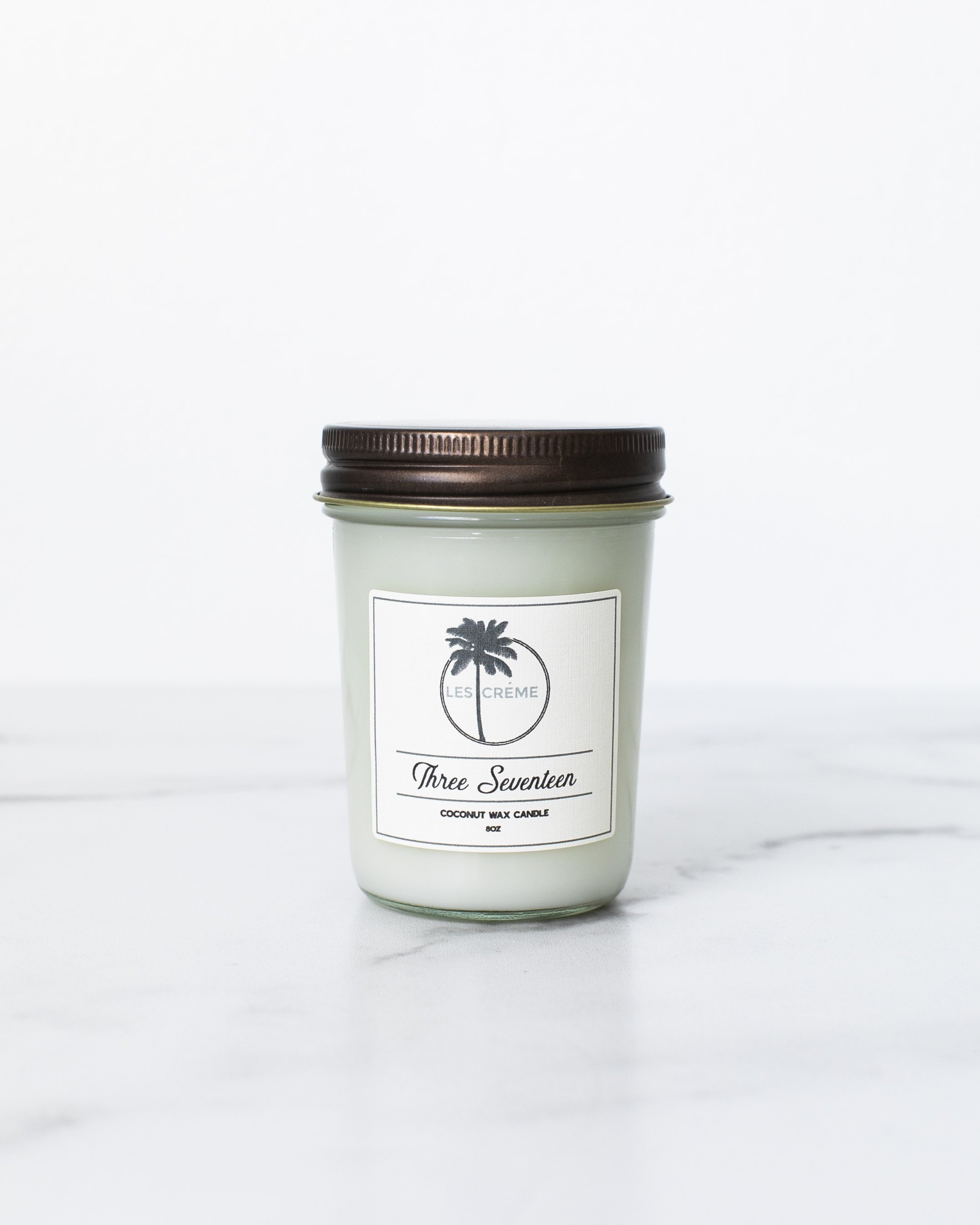 Three Seventeen Coconut Wax Candle in a stylish jar, showcasing its earthy and musky scent, perfect for home decor.