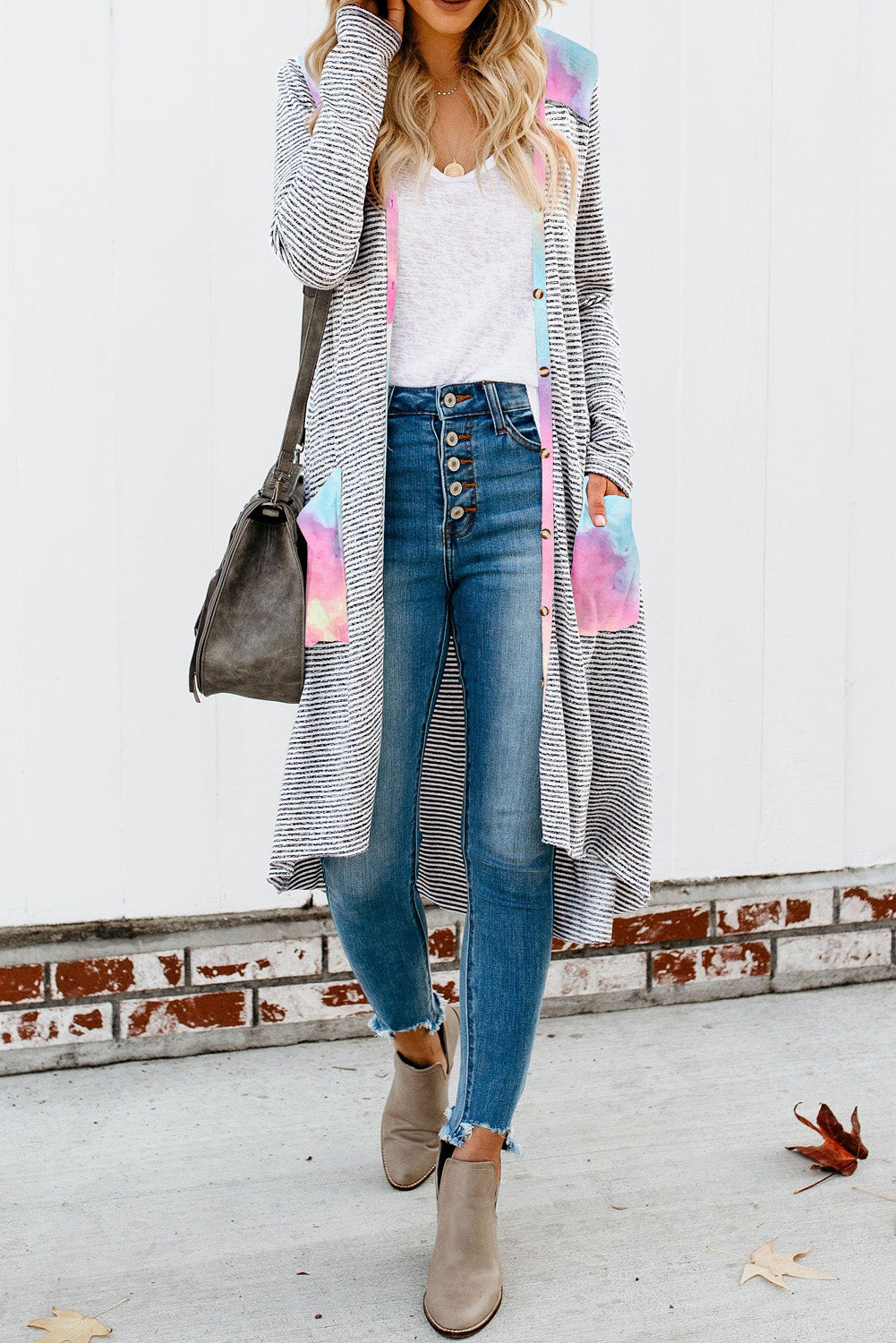 A stylish long striped cardigan featuring a vibrant tie-dye patchwork design, complete with pockets for convenience.