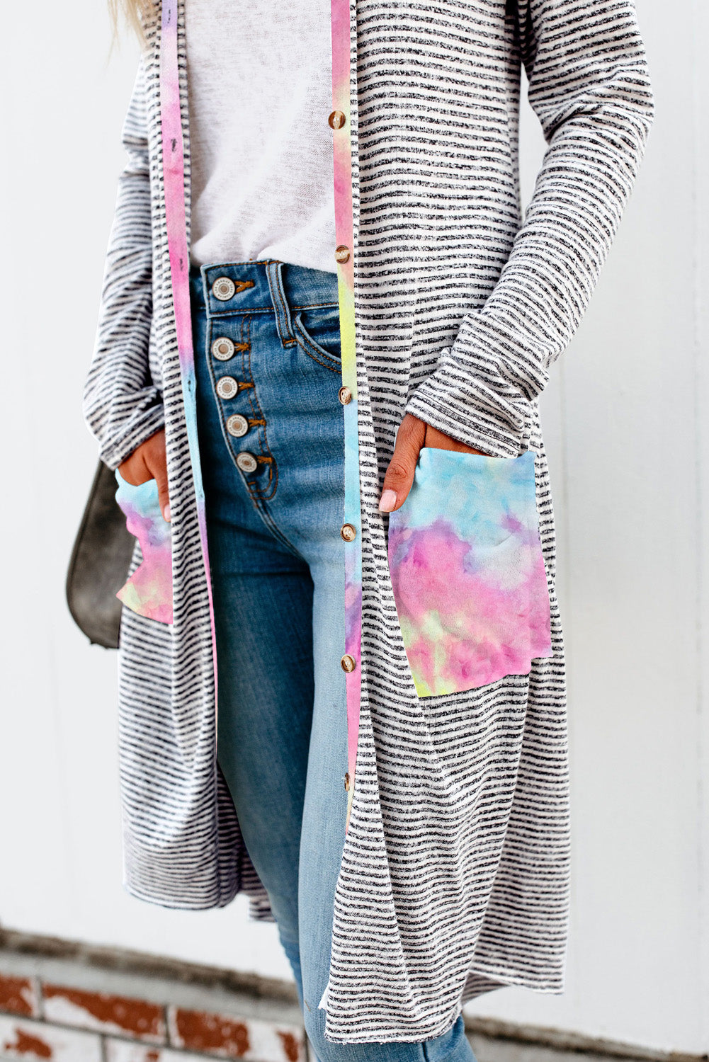 A stylish long striped cardigan featuring a vibrant tie-dye patchwork design, complete with pockets for convenience.