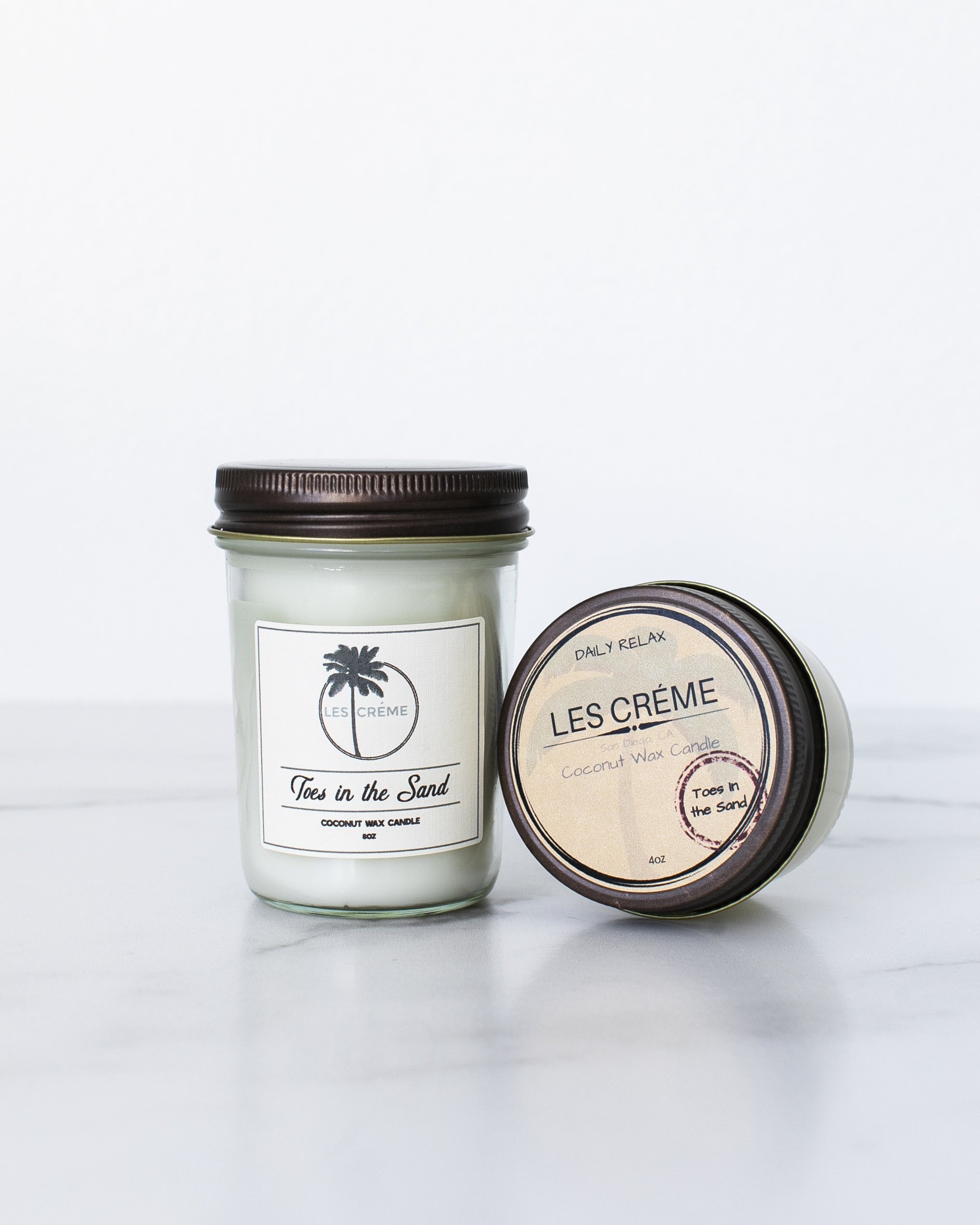 Toes in the Sand Coconut Wax Candle with floral design, showcasing its natural ingredients and elegant packaging.